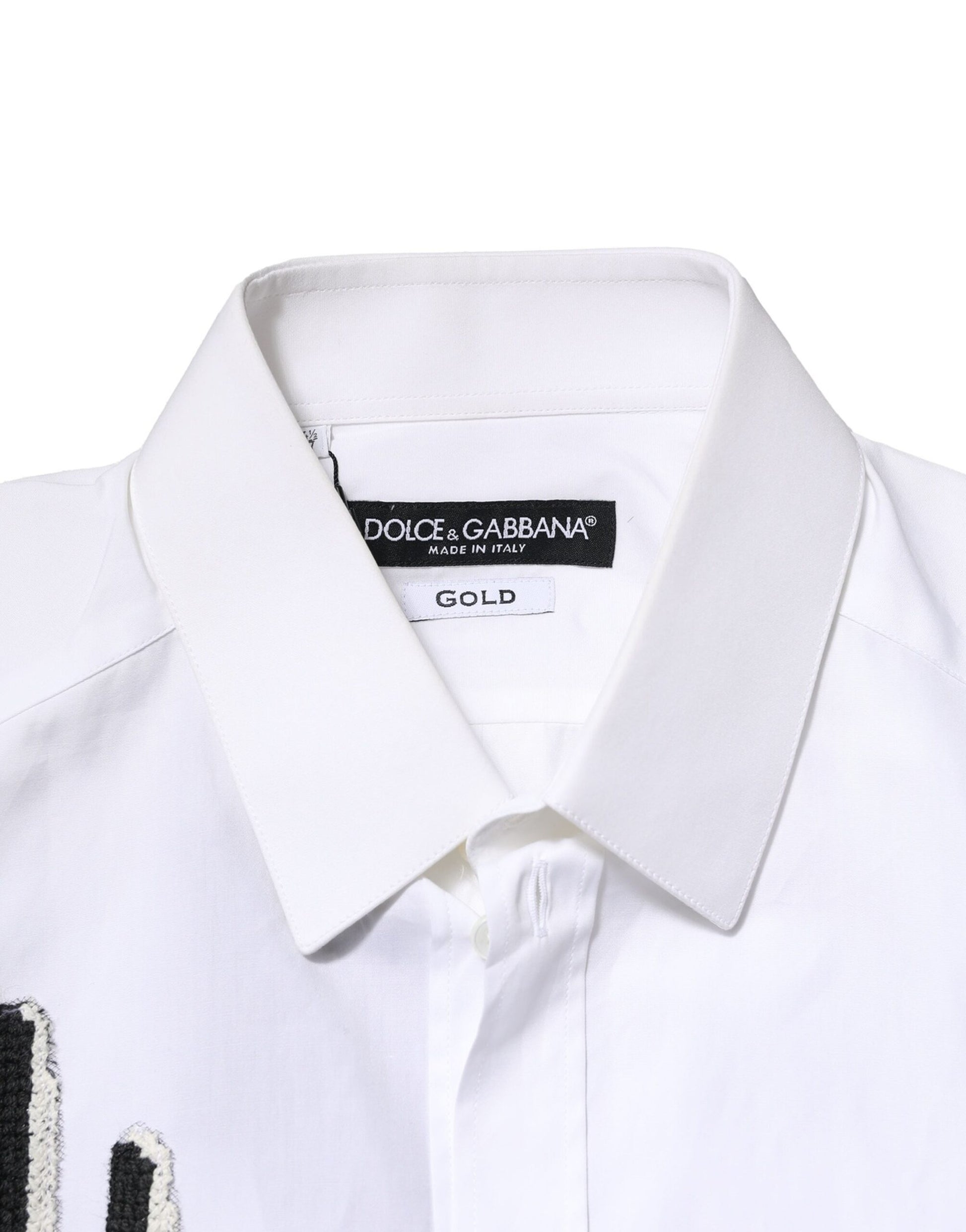 A white dress shirt with gold embroidery detailing from the brand Dolce & Gabbana
