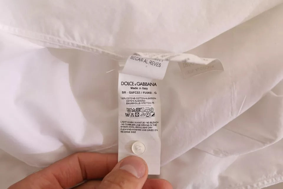 A white formal cotton tuxedo dress shirt with gold accents, from the brand Dolce & Gabbana