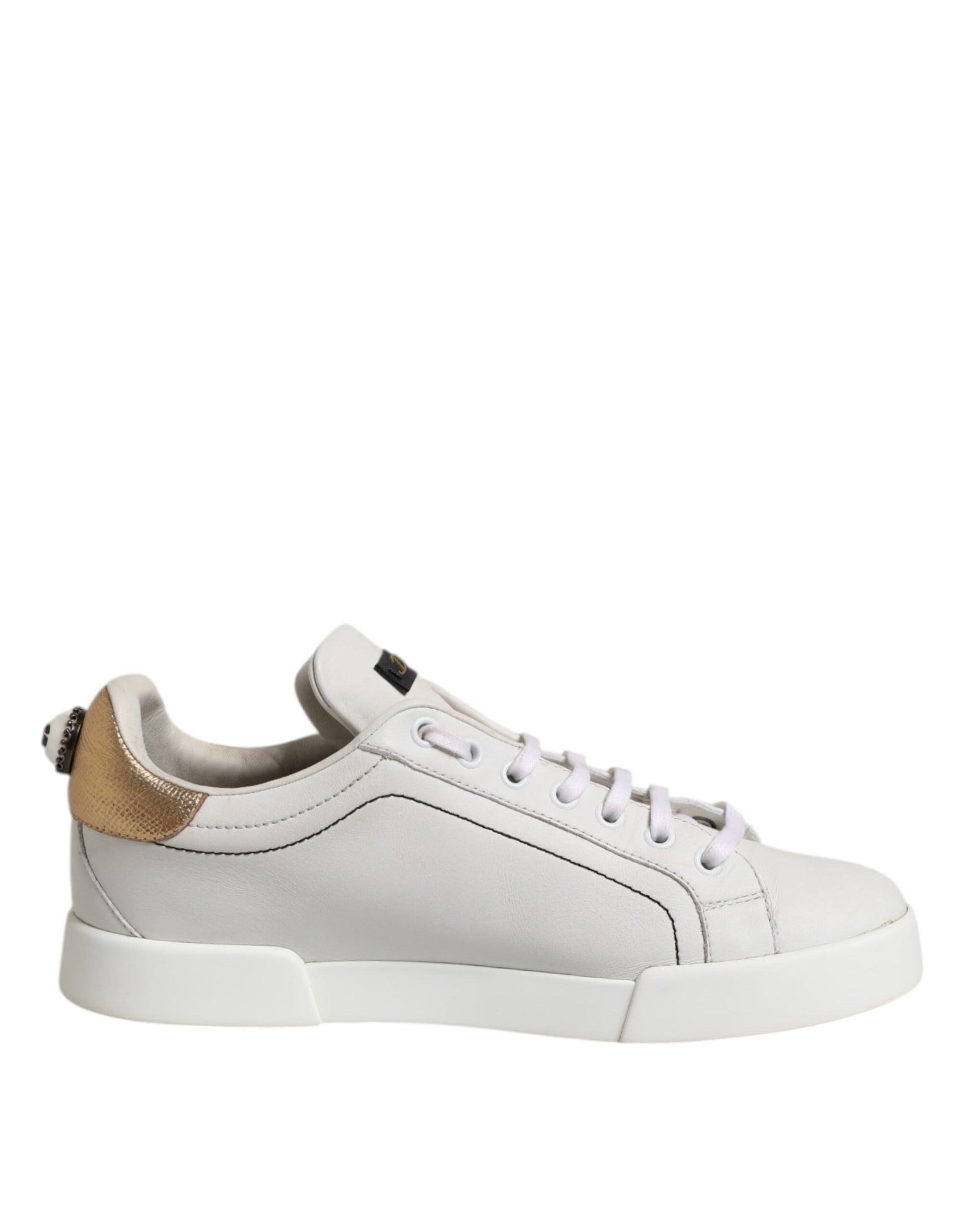 White sneaker with gold accents and white laces