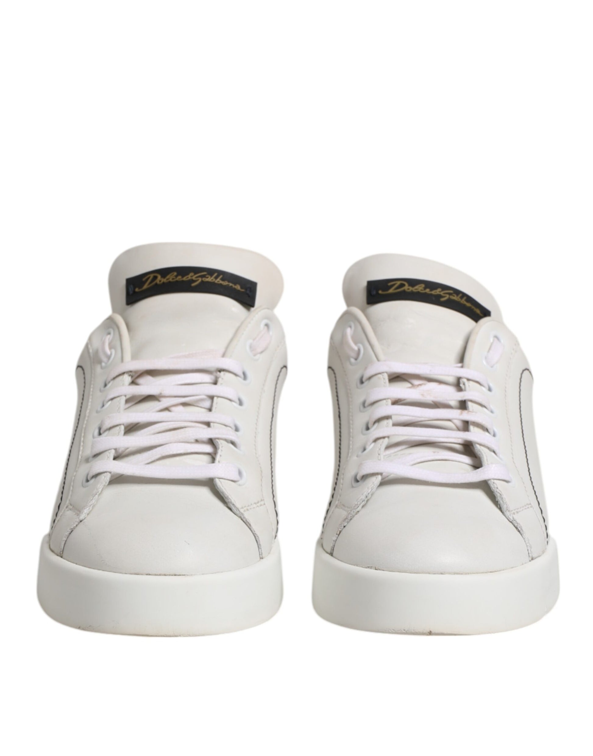 Pair of white sneakers with pink laces