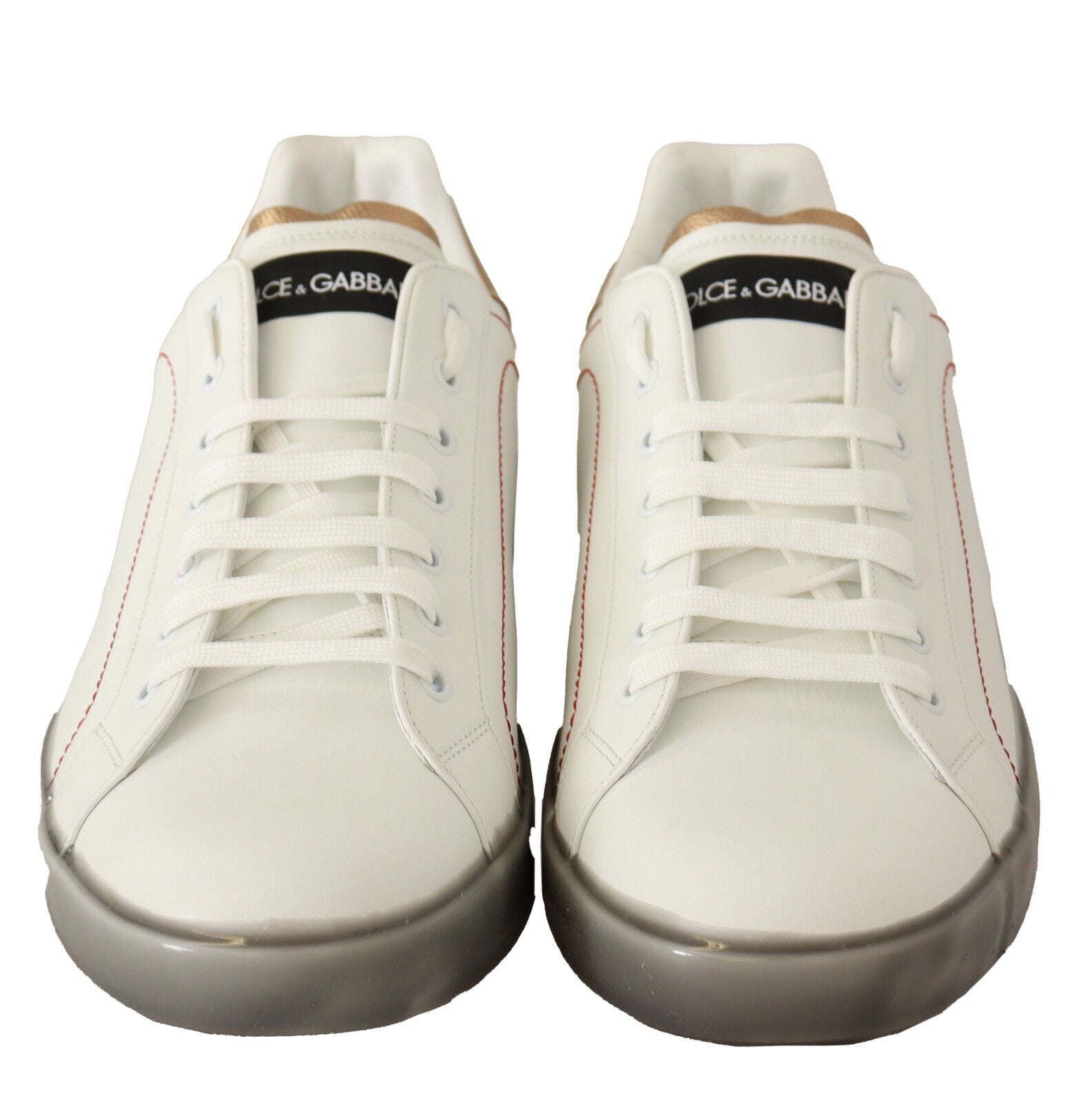 Pair of white sneakers with red accents and black laces