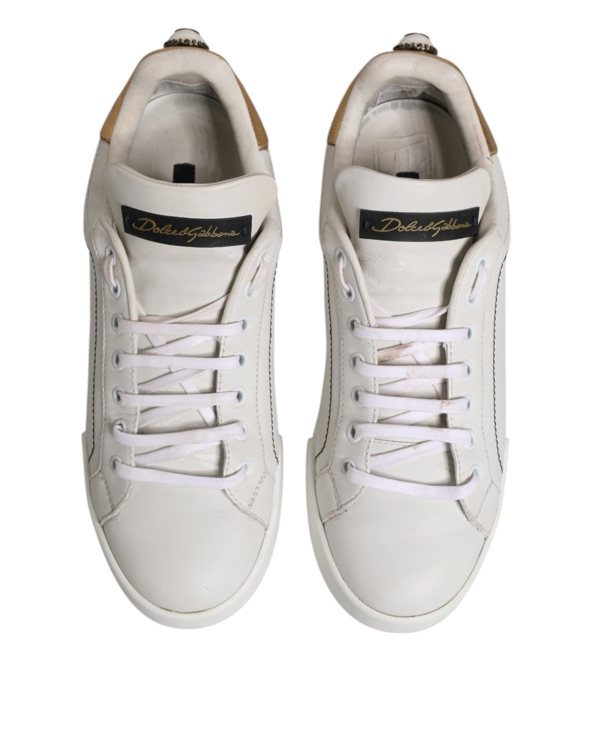 Pair of white sneakers with gold accents