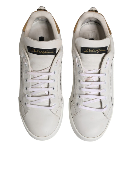 Pair of white sneakers with gold accents