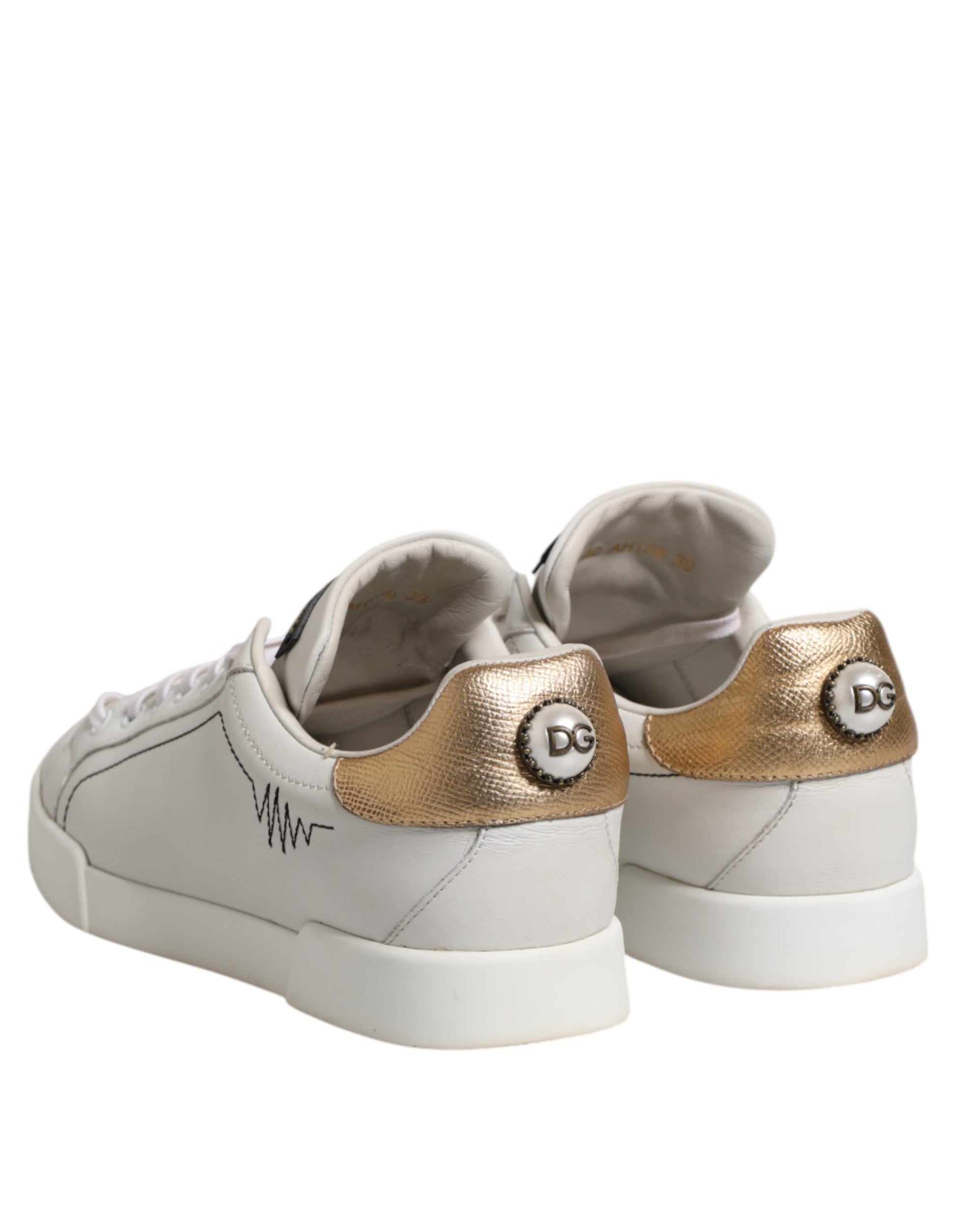 Pair of white sneakers with gold accents