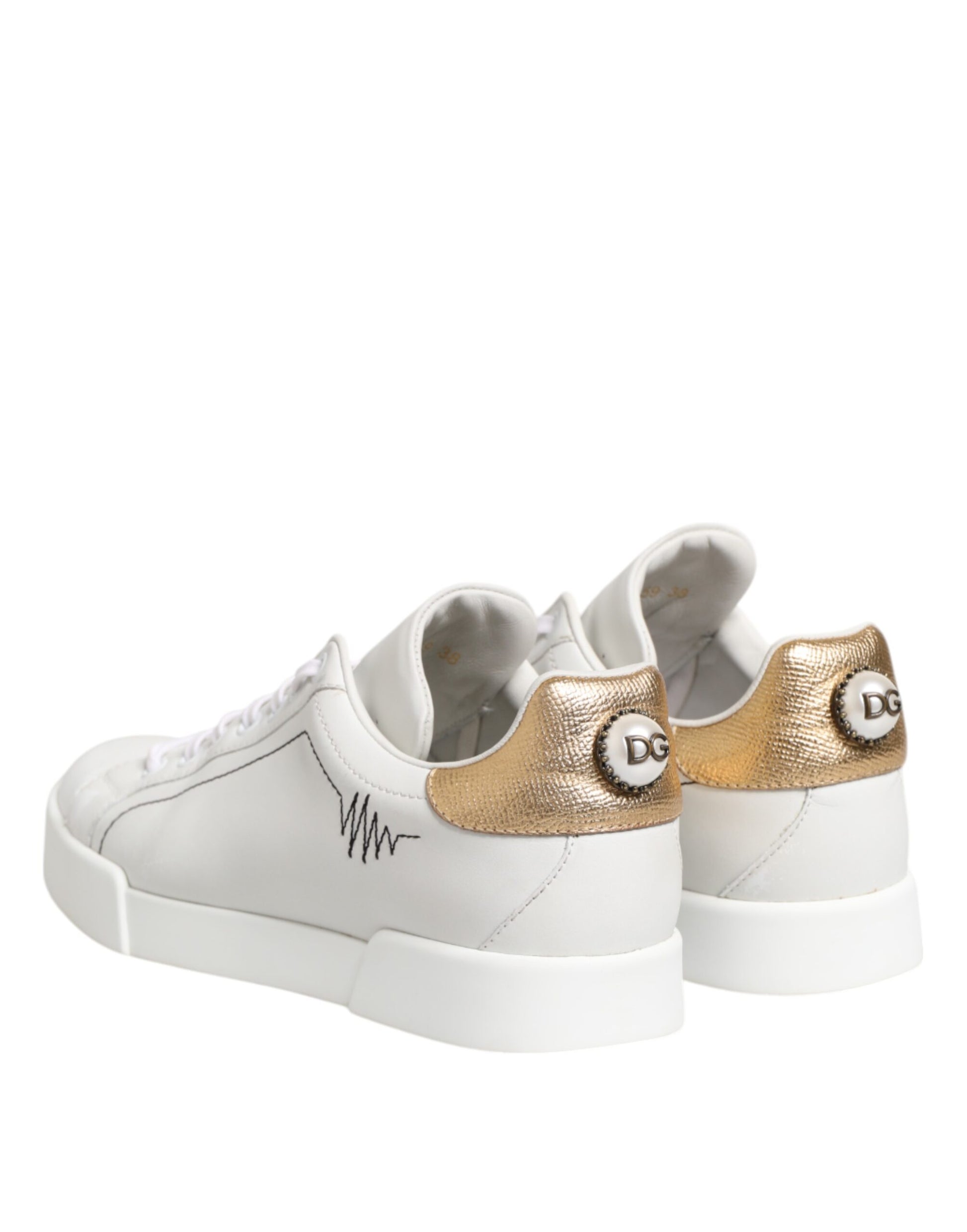 Pair of white gold leather sneakers with low top, featuring a logo on the side