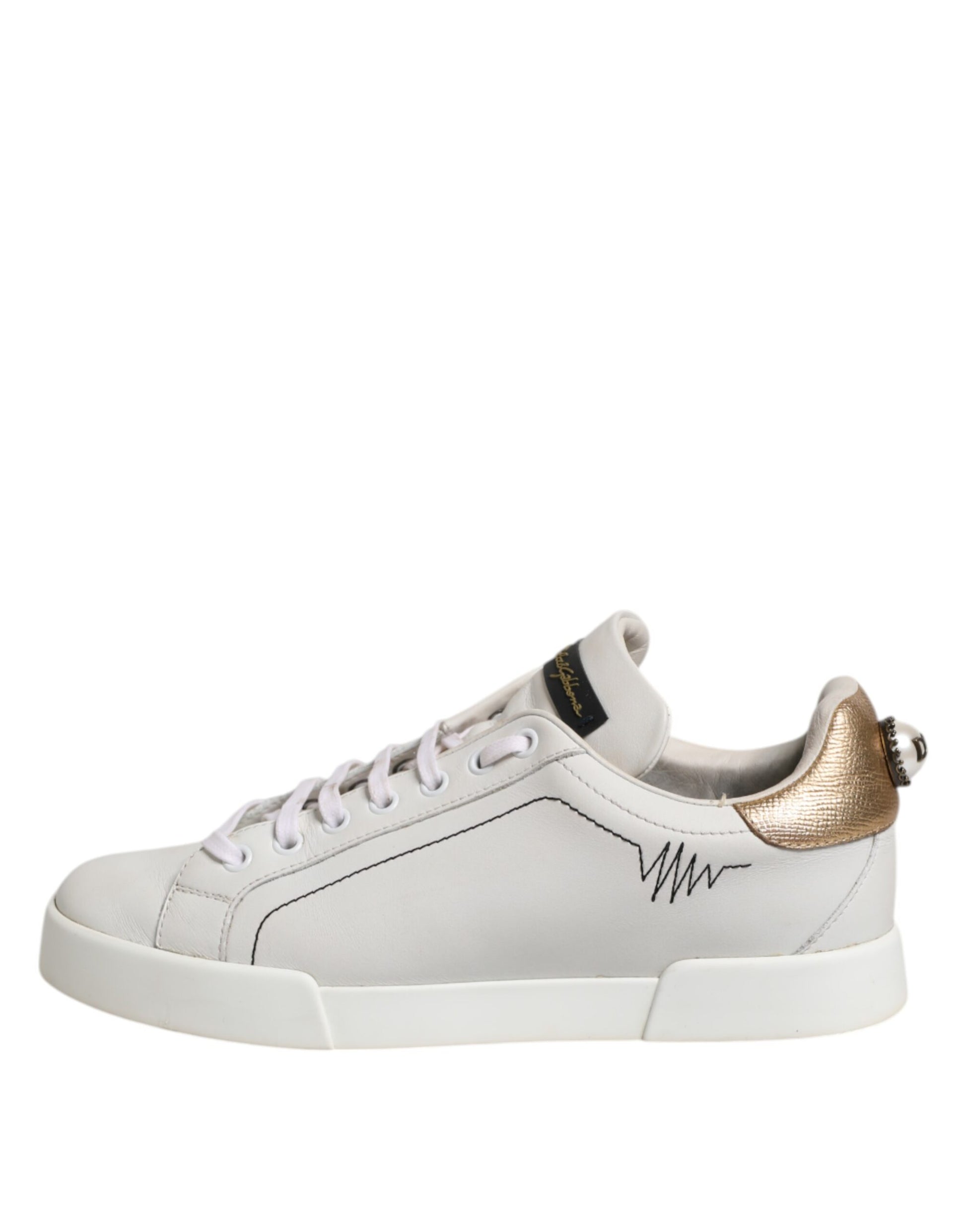 White sneaker with gold accents on laces and side stripe