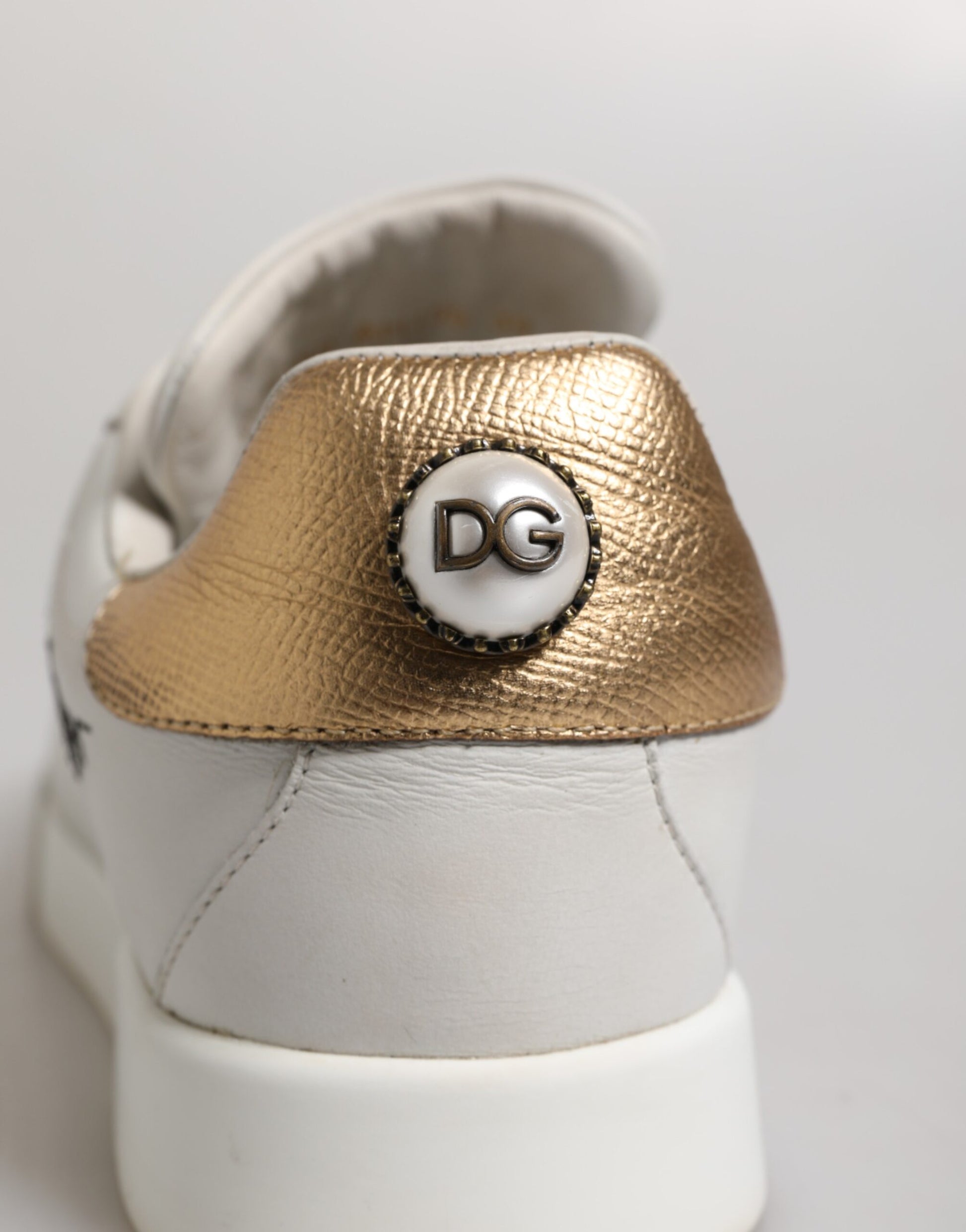 Gold shoe laces on white sneakers