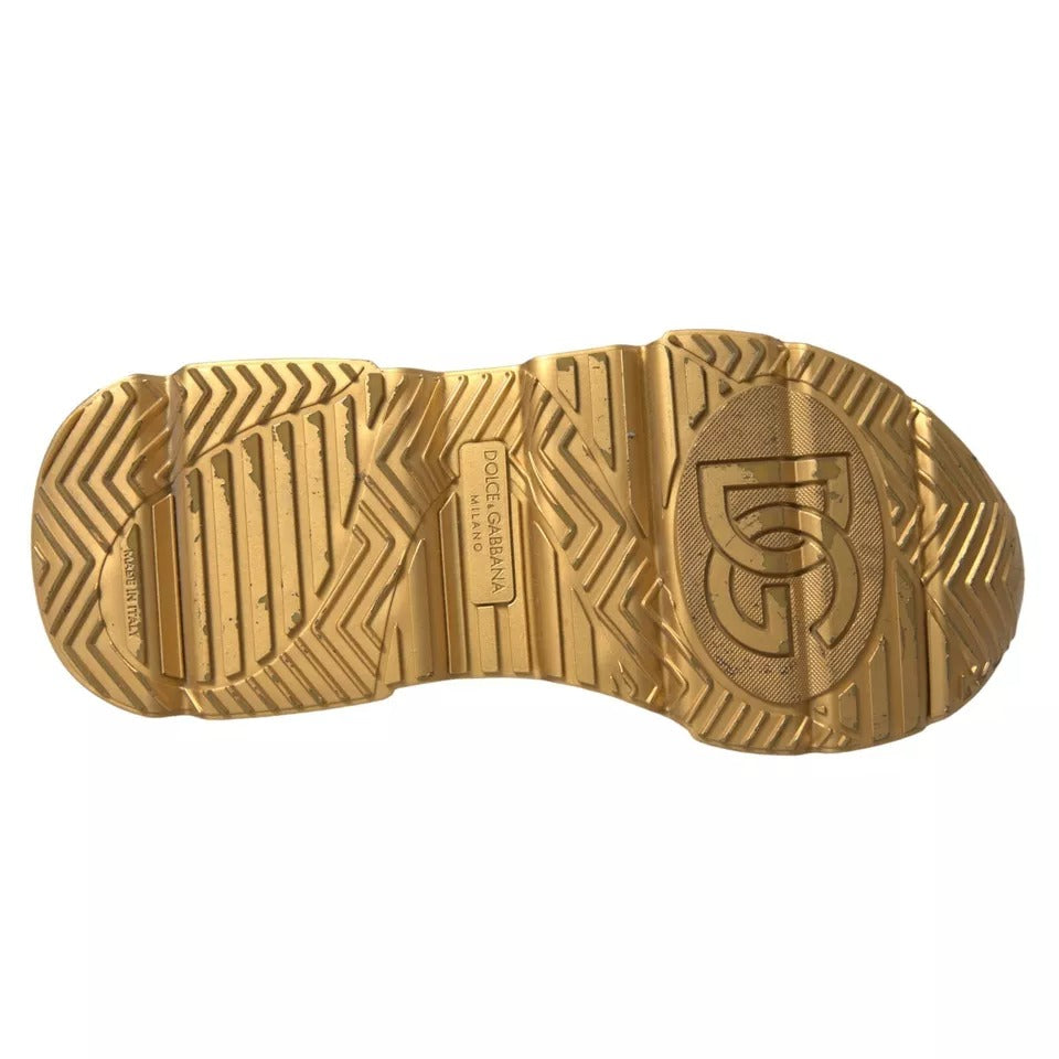A pair of gold leather men's sneakers with a white sole, featuring the D&G logo