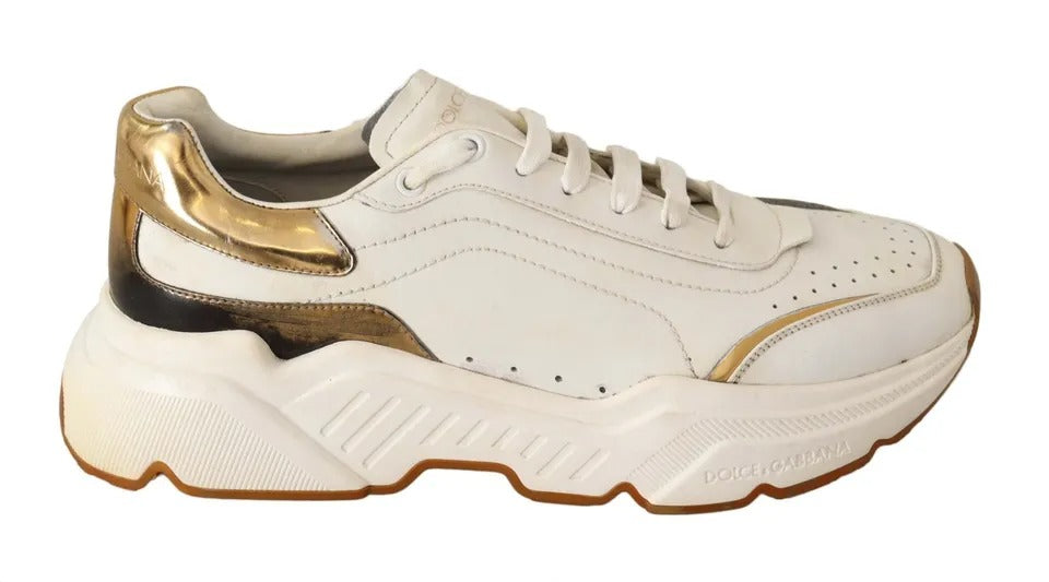 White gold leather sneakers with laces, featuring a sporty design and a logo on the side