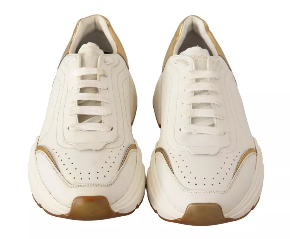 Pair of white gold leather sport shoes with laces and logo on side