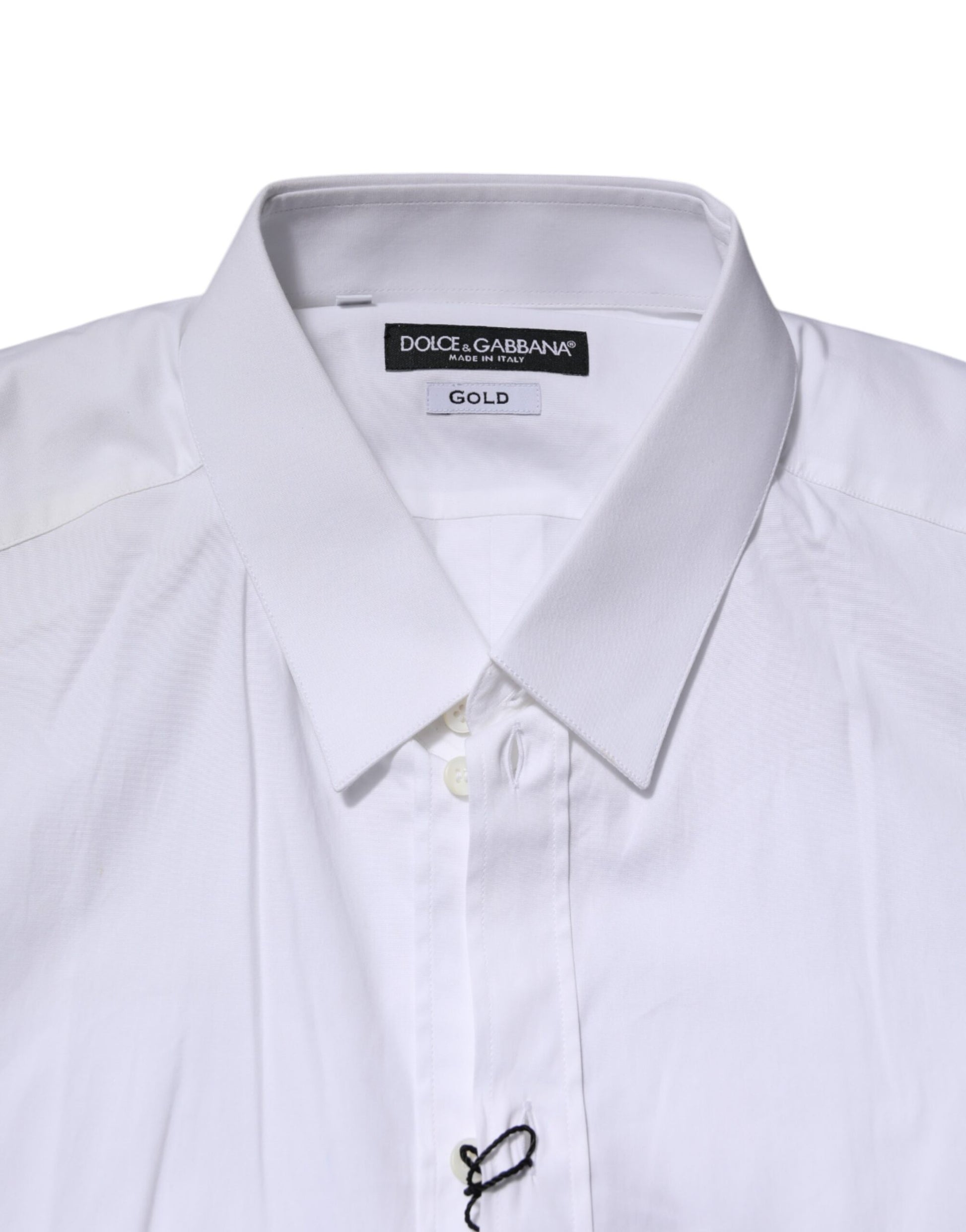 A white long sleeve dress shirt with a gold label on the collar