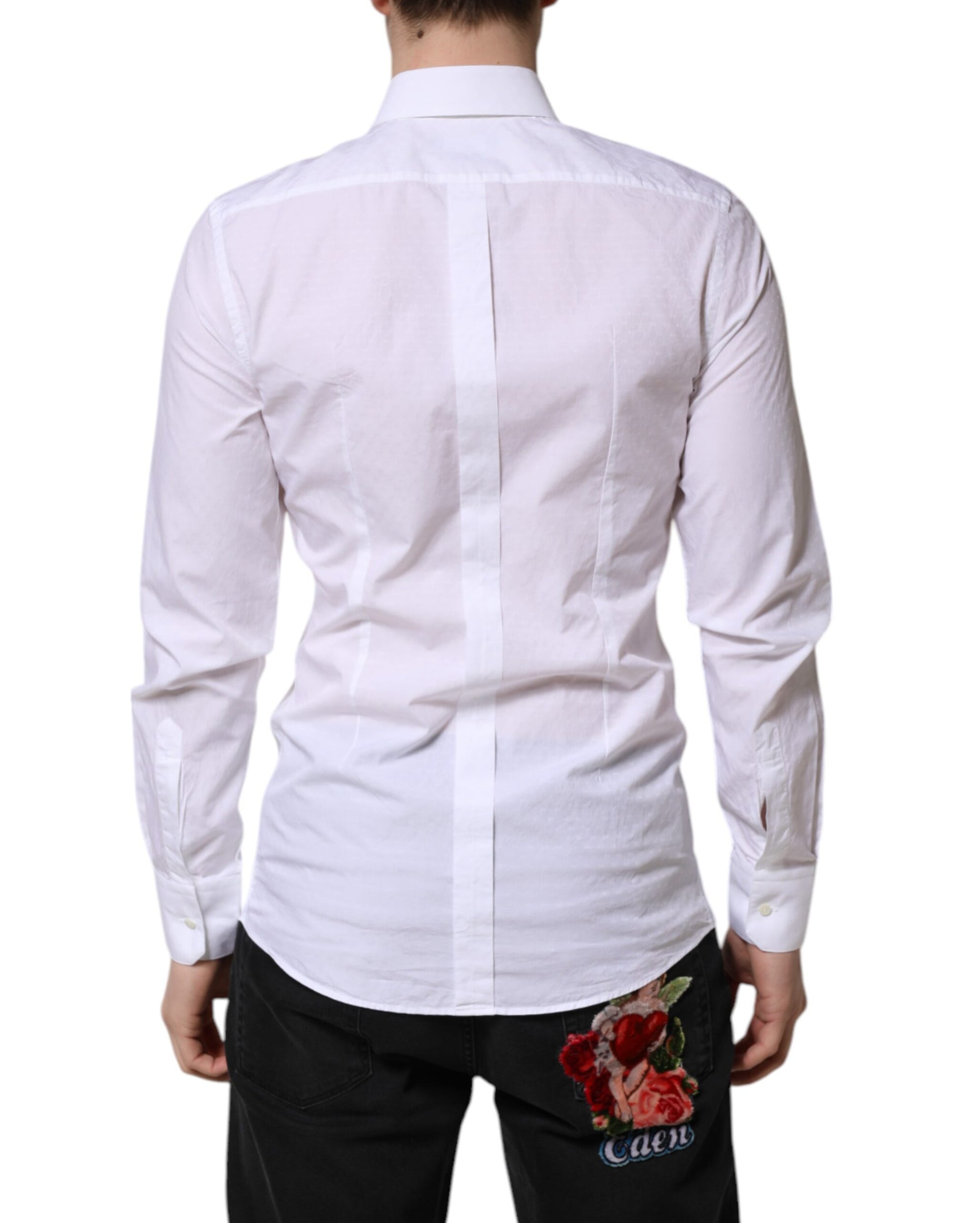 A mannequin wearing a white long sleeve dress shirt with gold accents. The shirt features a collar and is des