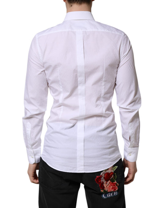 A mannequin wearing a white long sleeve dress shirt with gold accents. The shirt features a collar and is des