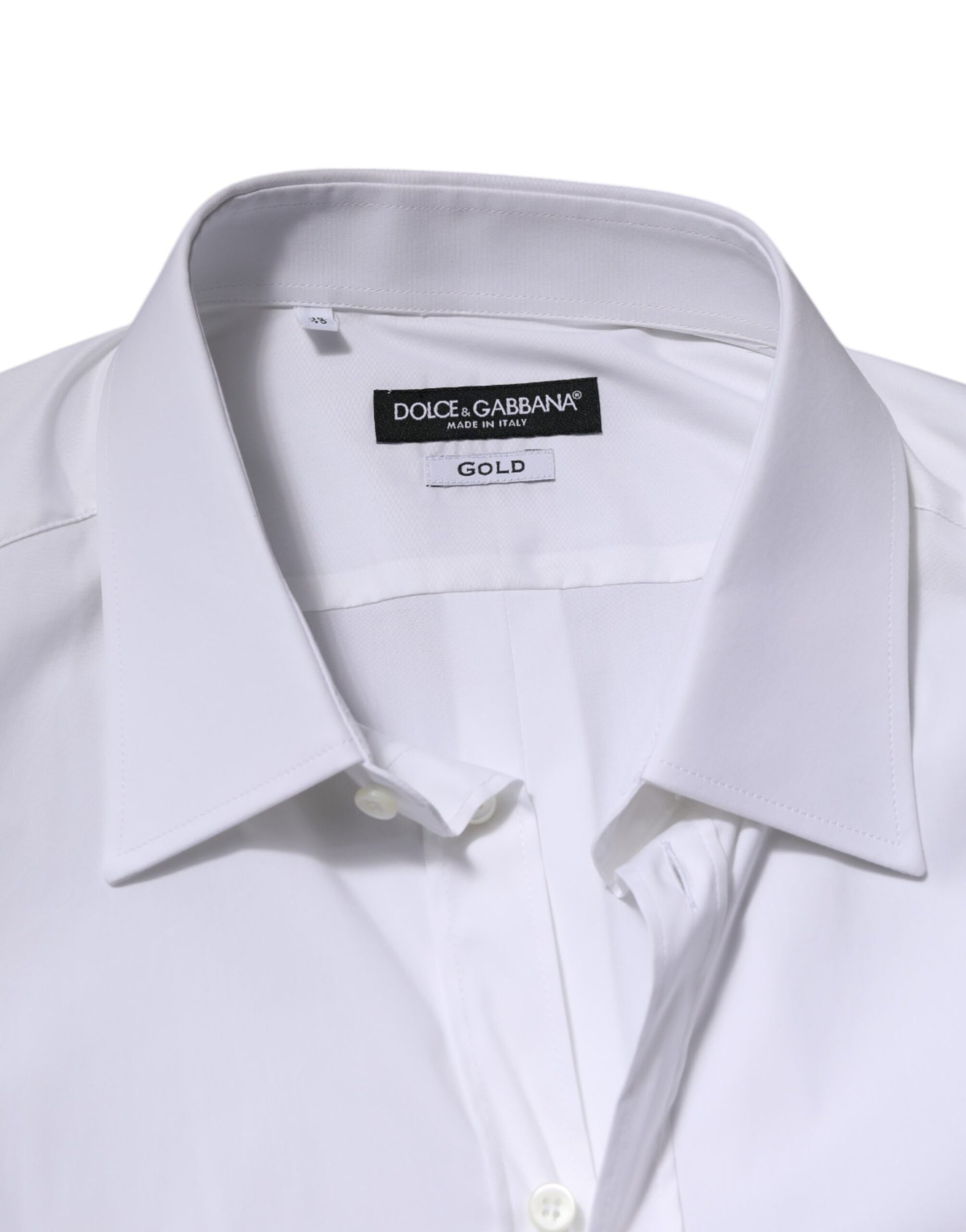 A white long sleeve dress shirt with a gold label on the collar