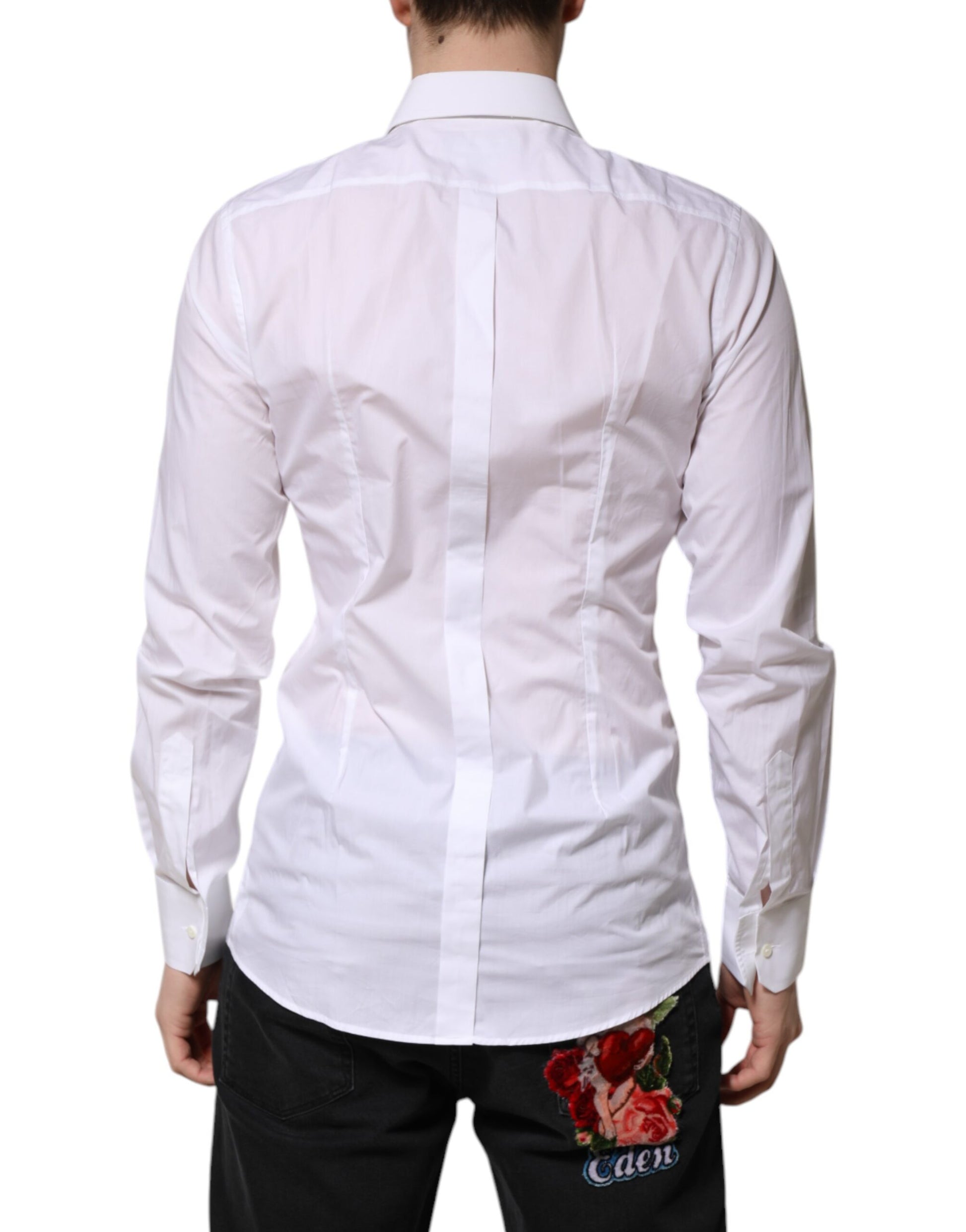 A long sleeve white shirt with gold accents, featuring a floral embroidered detail on the back