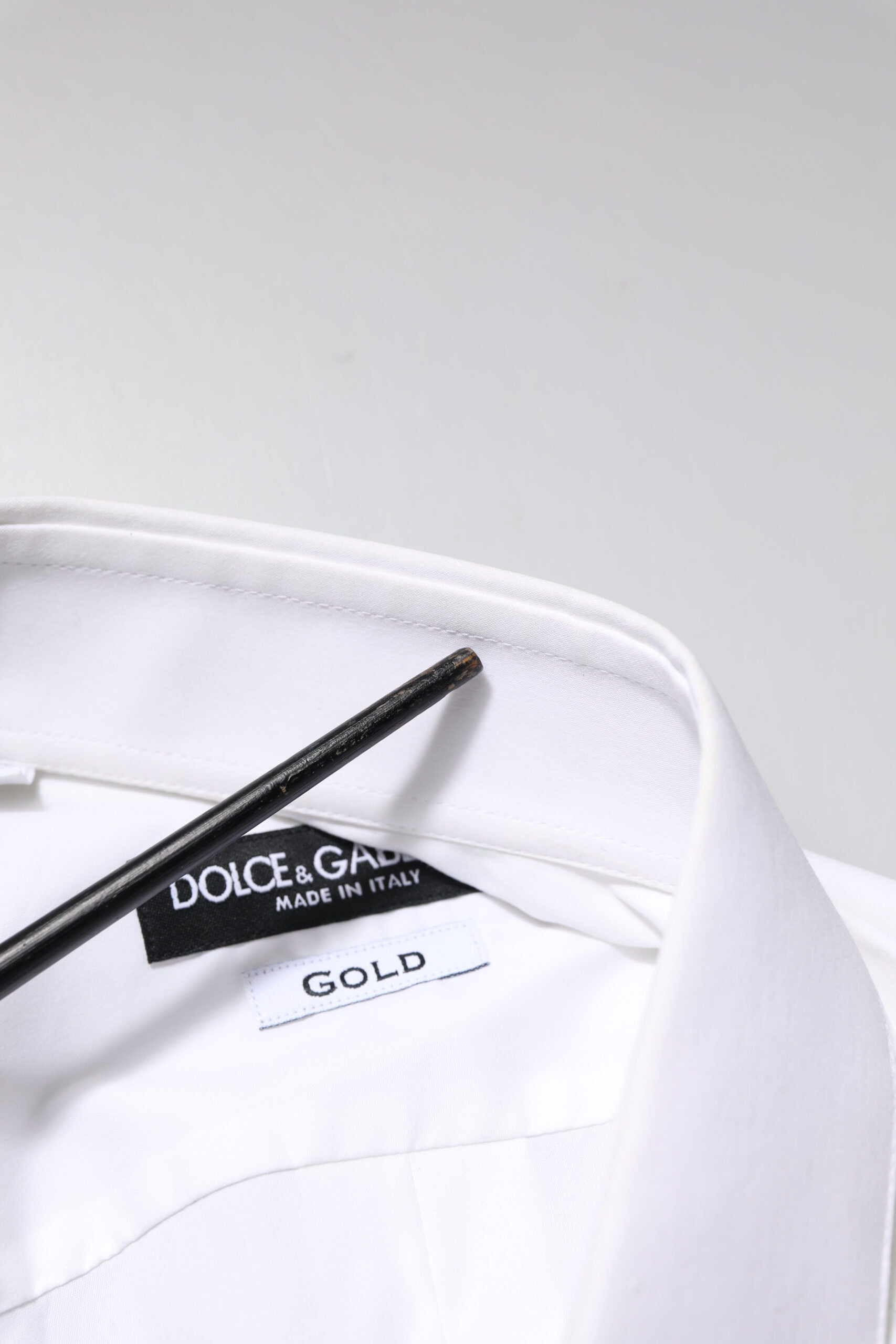 A white long sleeve dress shirt with a gold label from Dolce & Gabbana