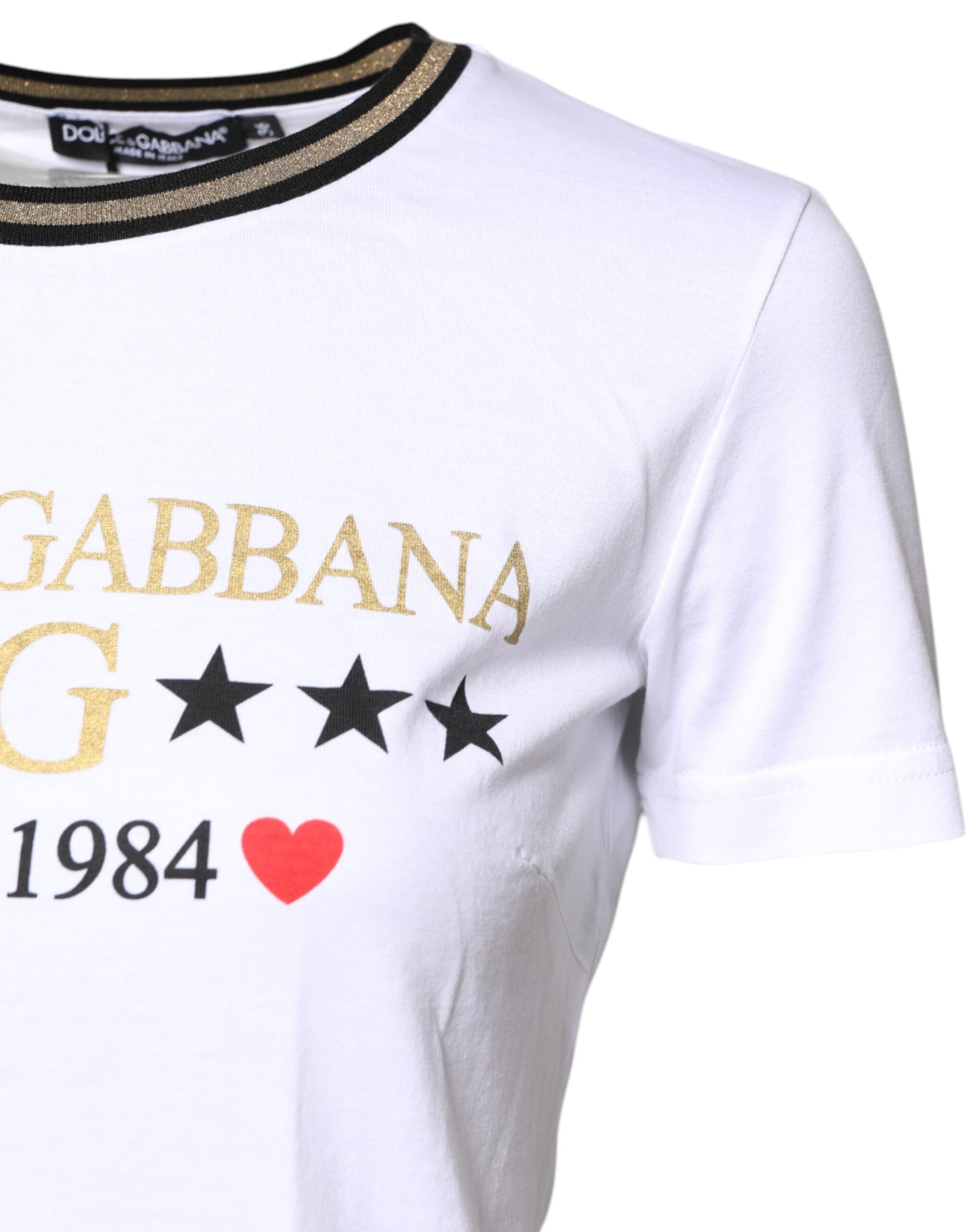 White t-shirt with gold lettering and stars
