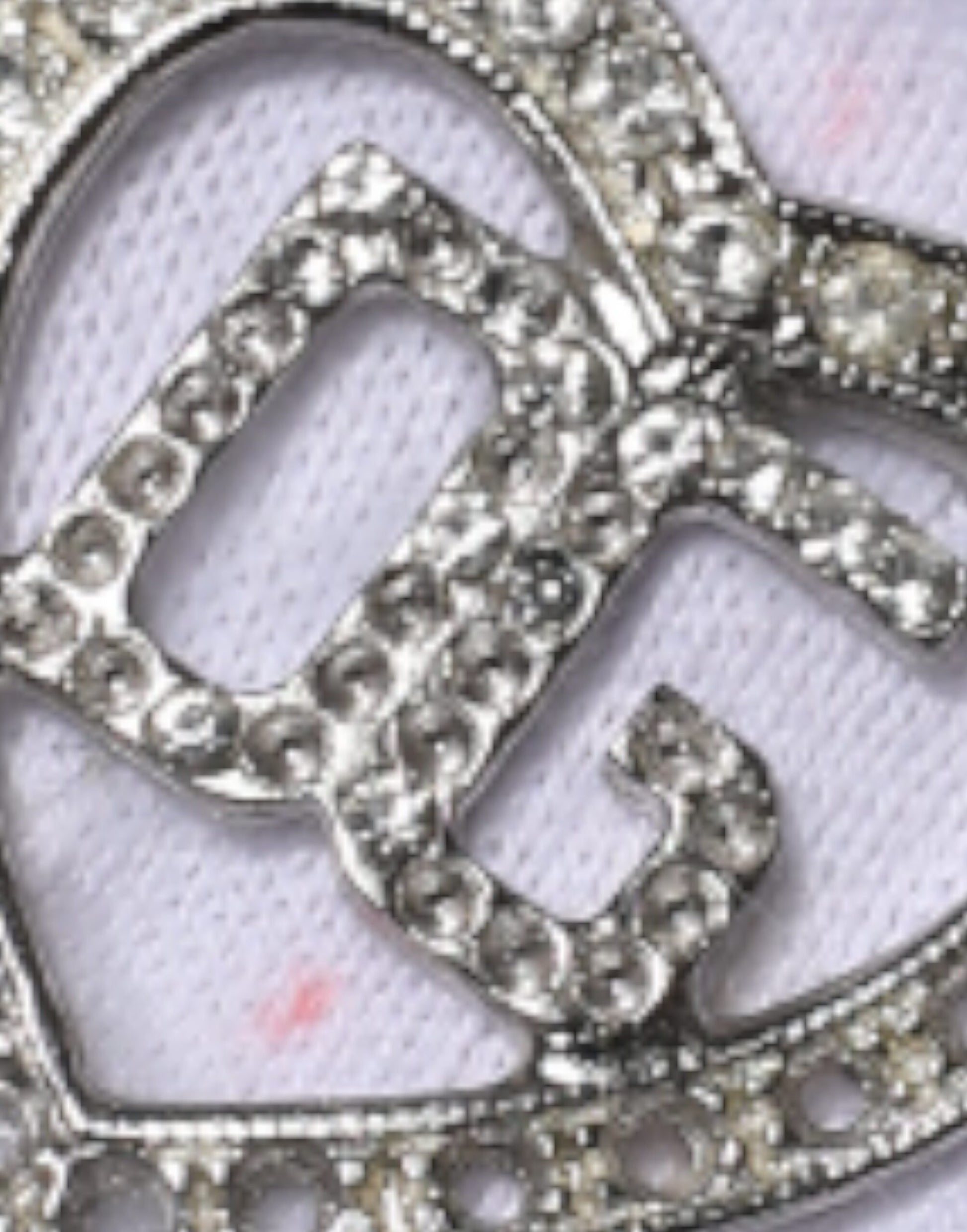 Silver jewelry with a letter 'C' in the center