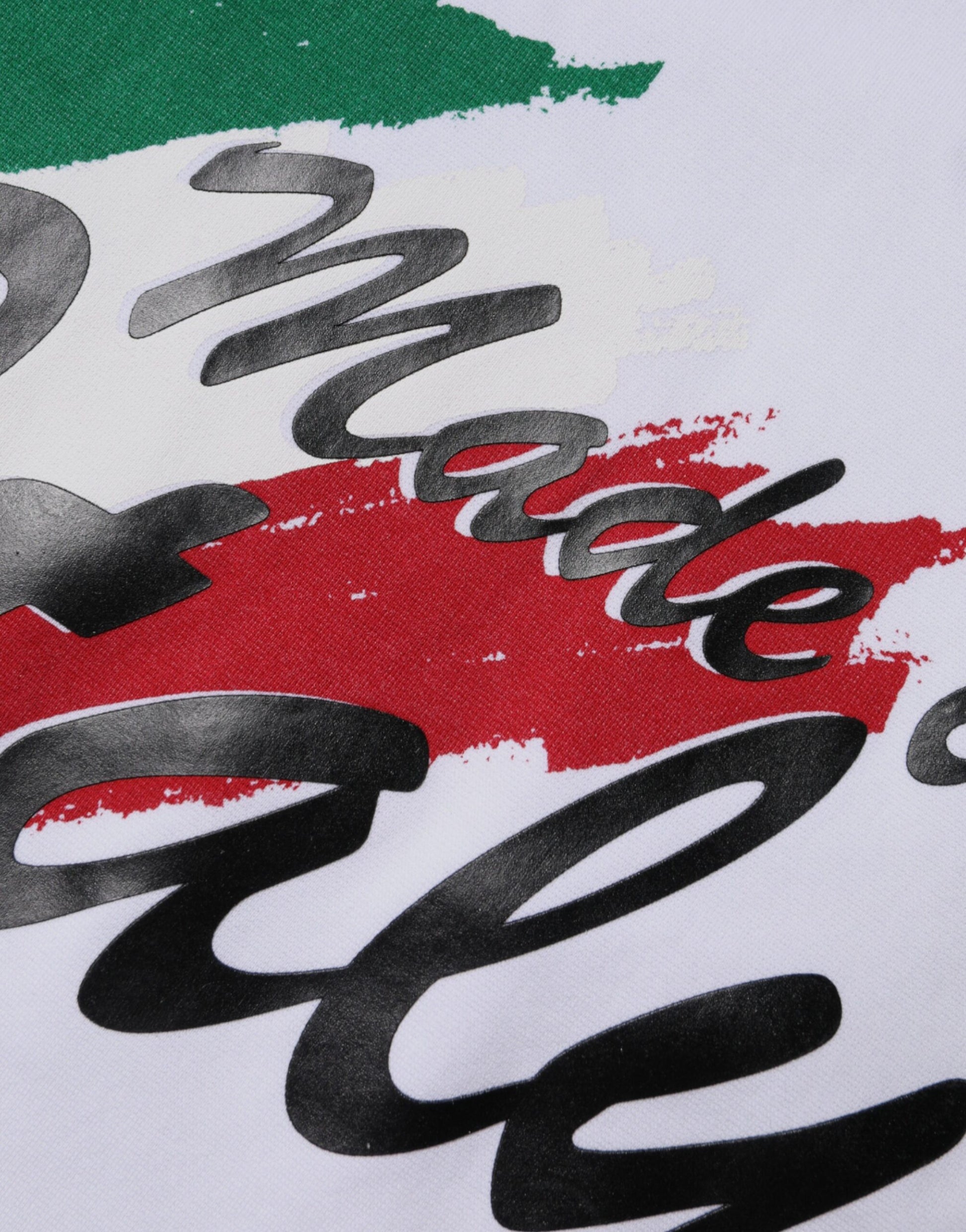 White t-shirt with red, green, and black design