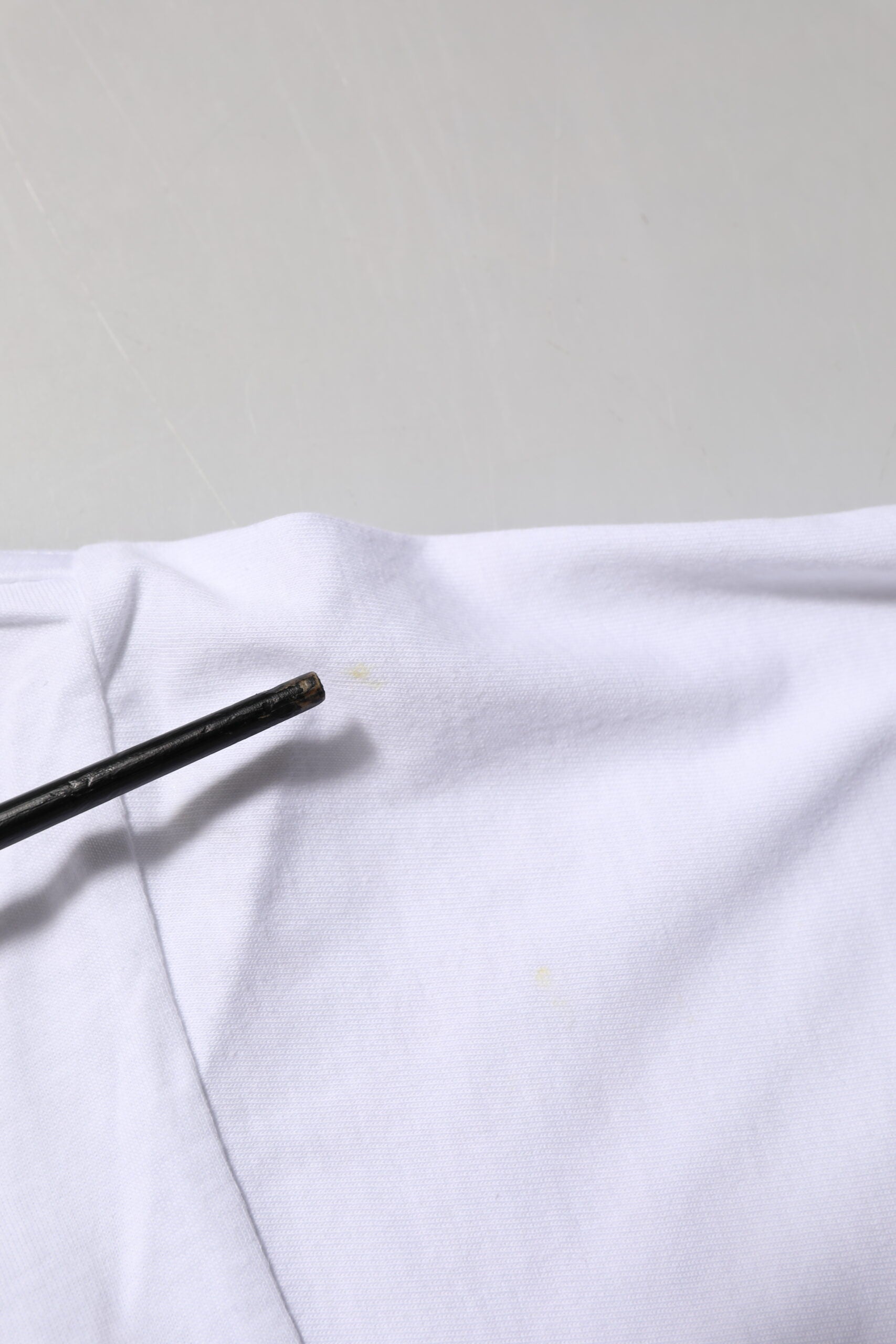 White shirt with black button