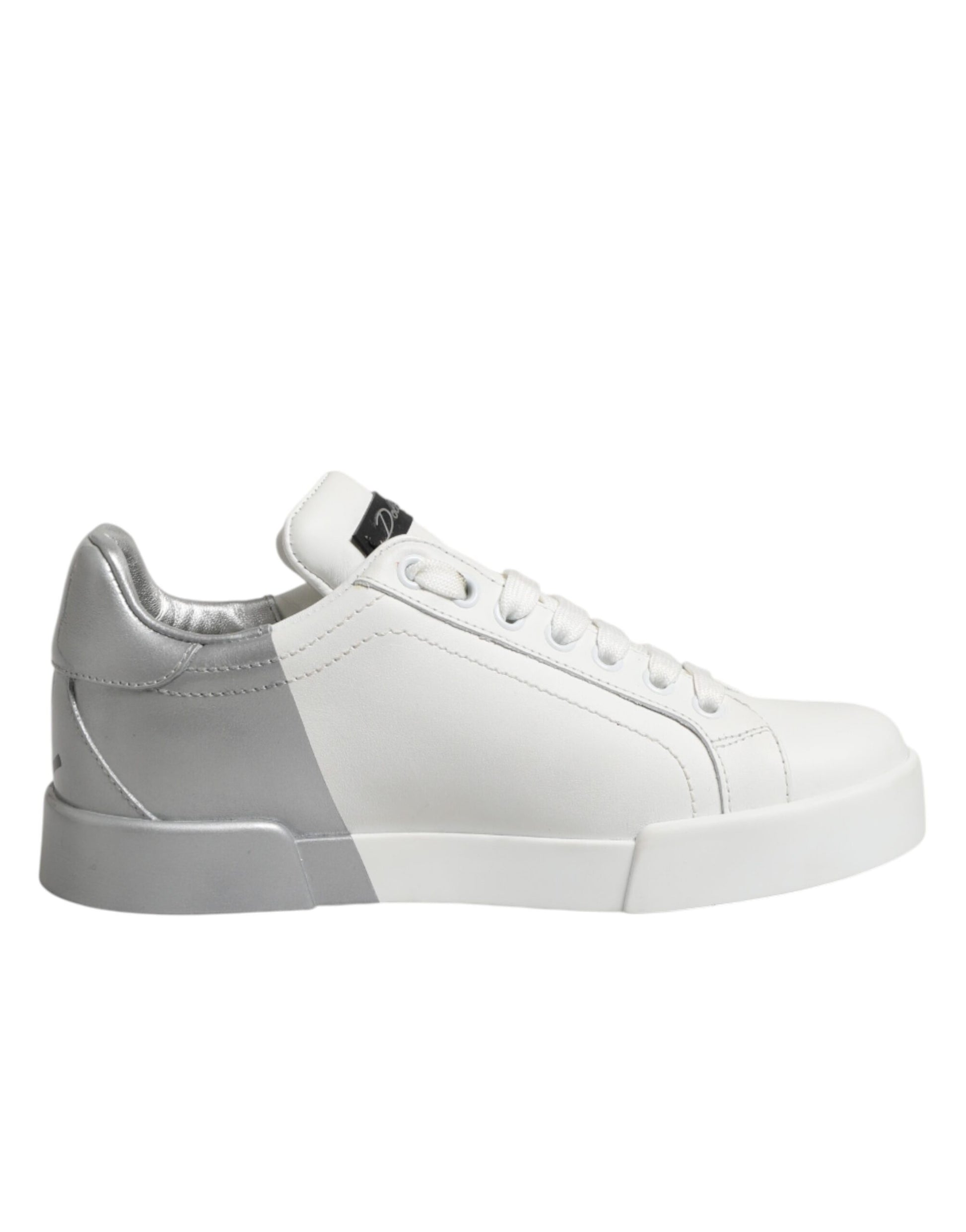A pair of white and gray low top leather sneakers with a lace-up front