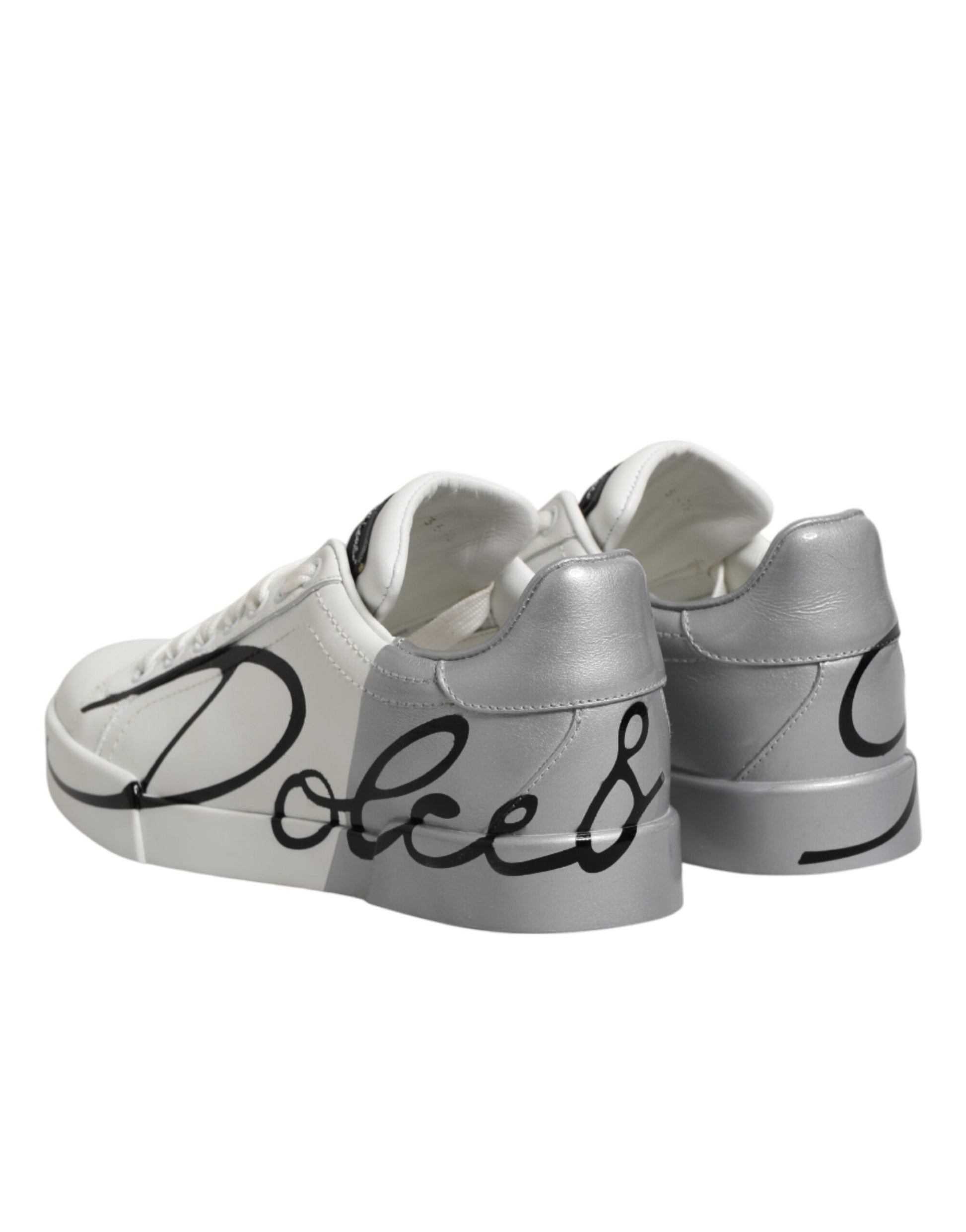 Pair of white gray leather sneakers with black text reading "Dolce & Gabbana"