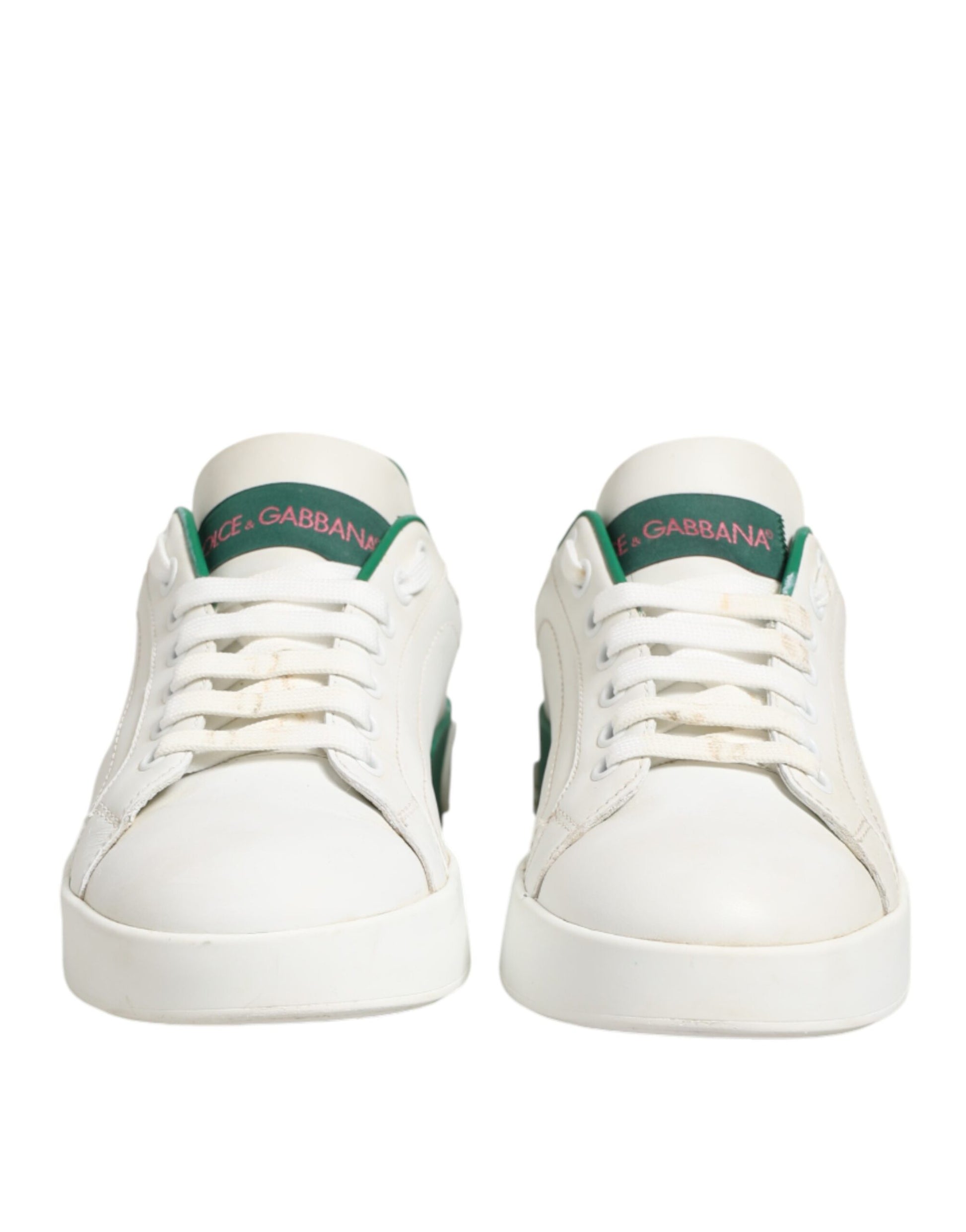 Pair of white sneakers with green accents