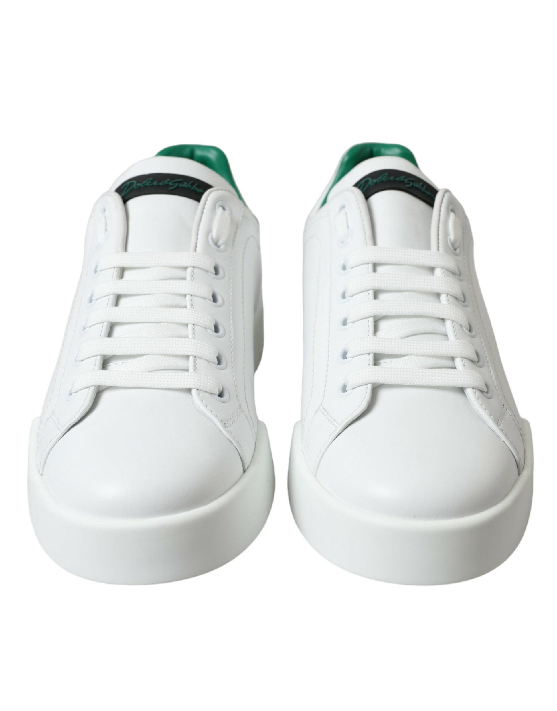 Pair of white sneakers with black laces and soles
