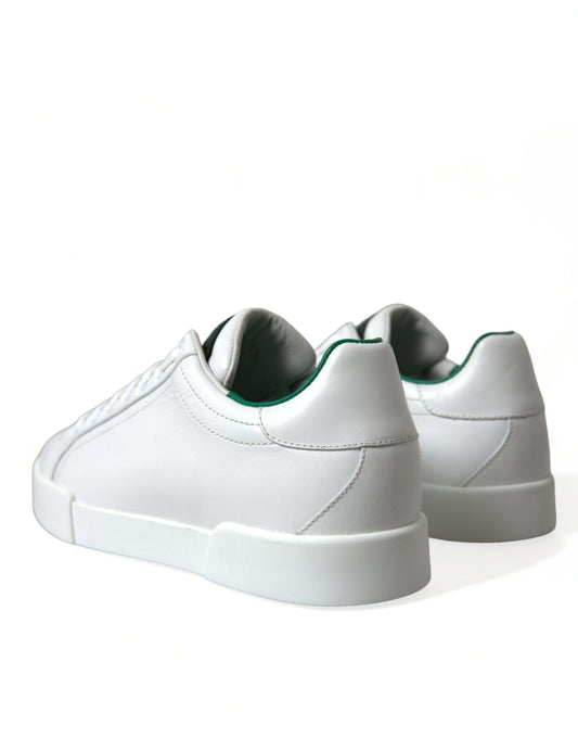 Pair of white sneakers with green accents and a low top design