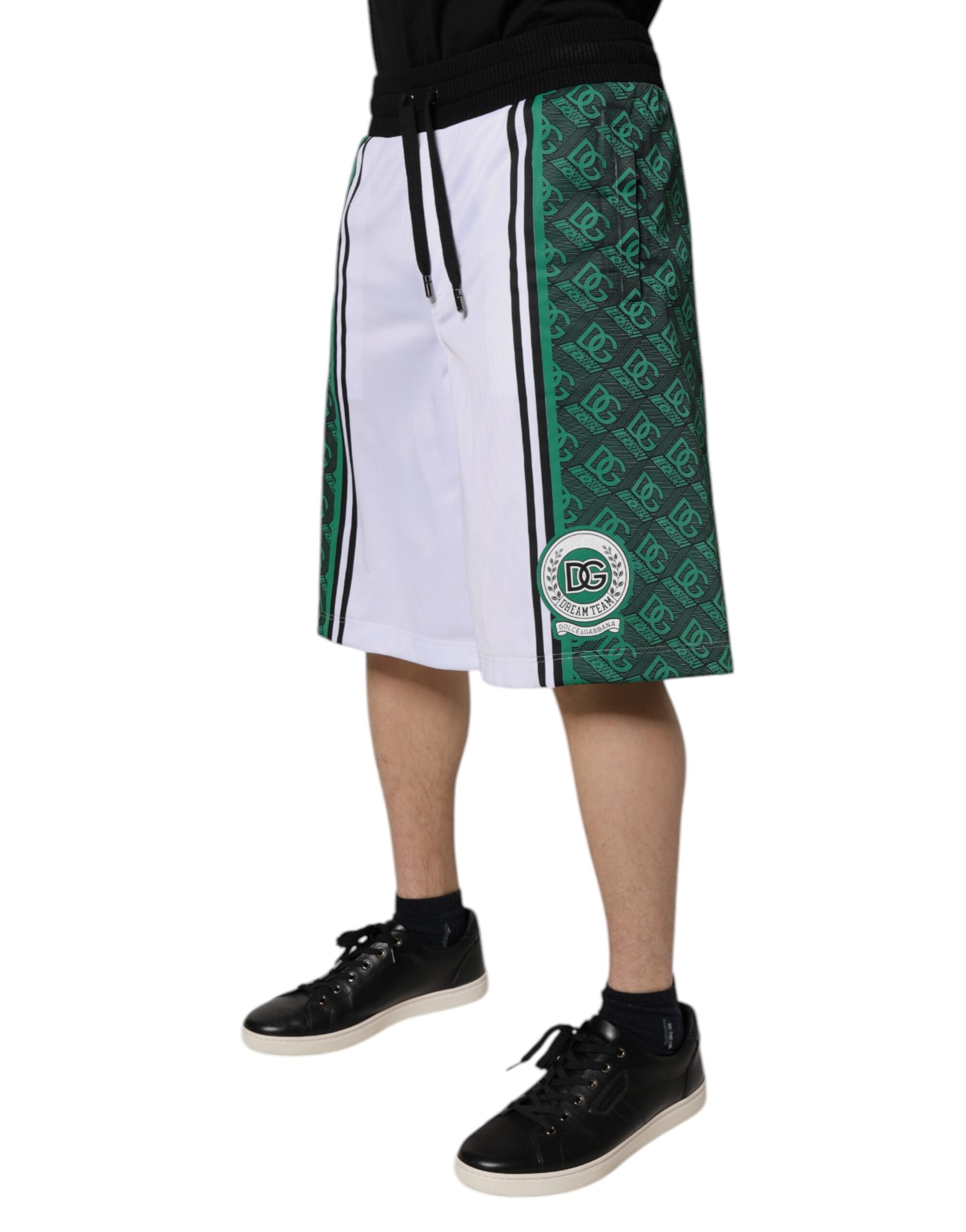 A pair of men's shorts with a white and green color scheme, featuring the Dolce & Gabbana logo. They are desi