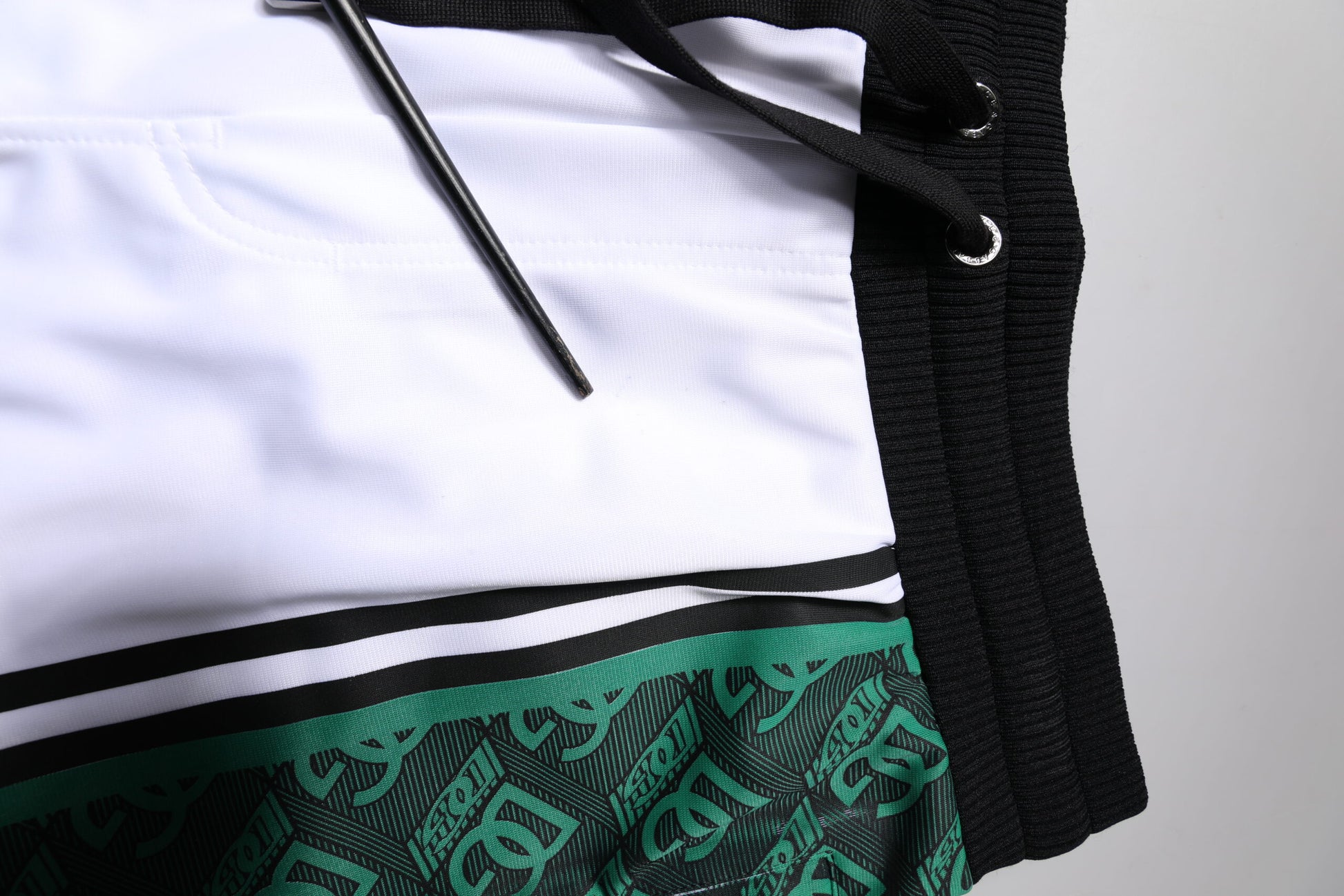 White and green men's jersey sweat shorts with brand logo detailing
