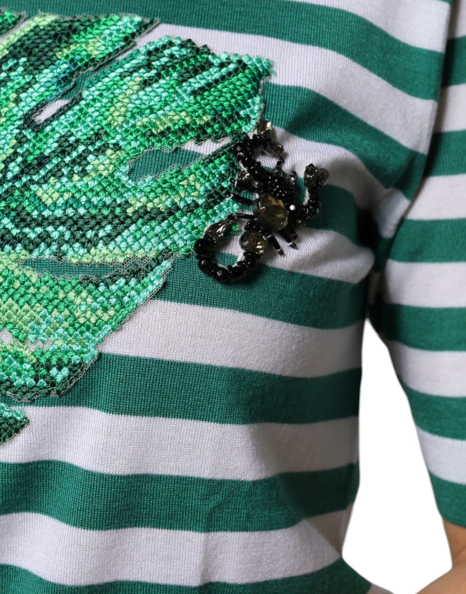 Green and white striped shirt with embroidered bird design on left chest area