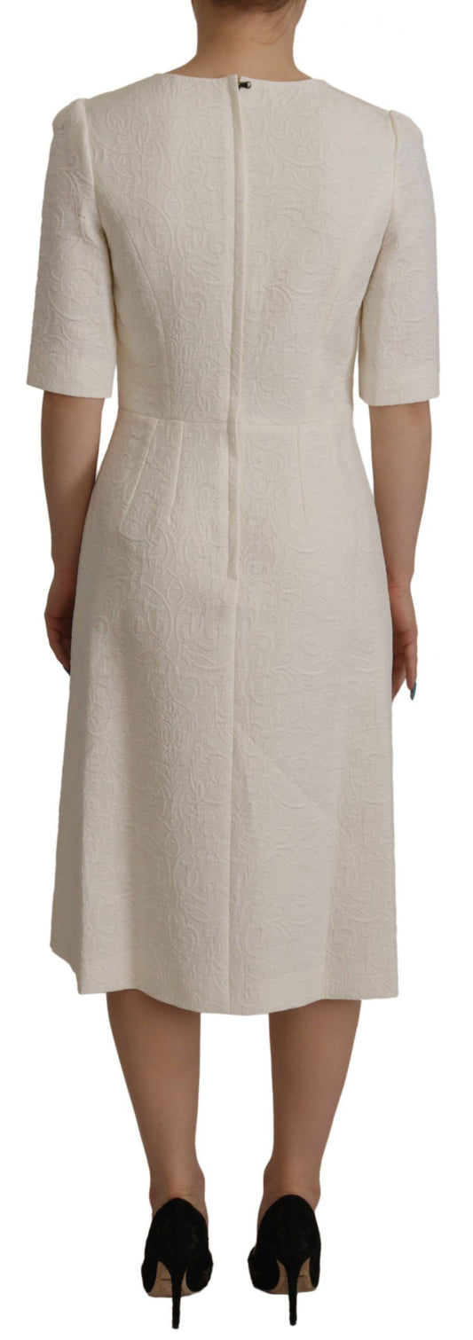 A white midi dress with floral brocade pattern, designed by Dolce & Gabbana