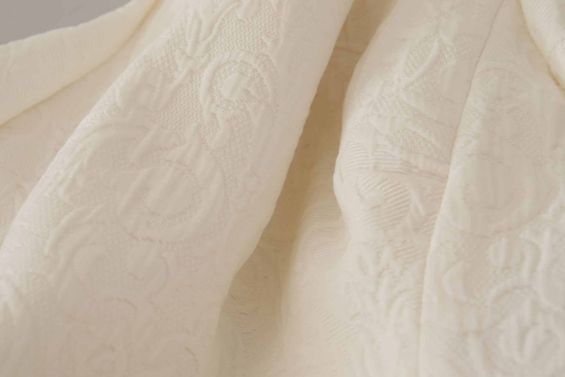A white floral brocade midi dress with lace detailing