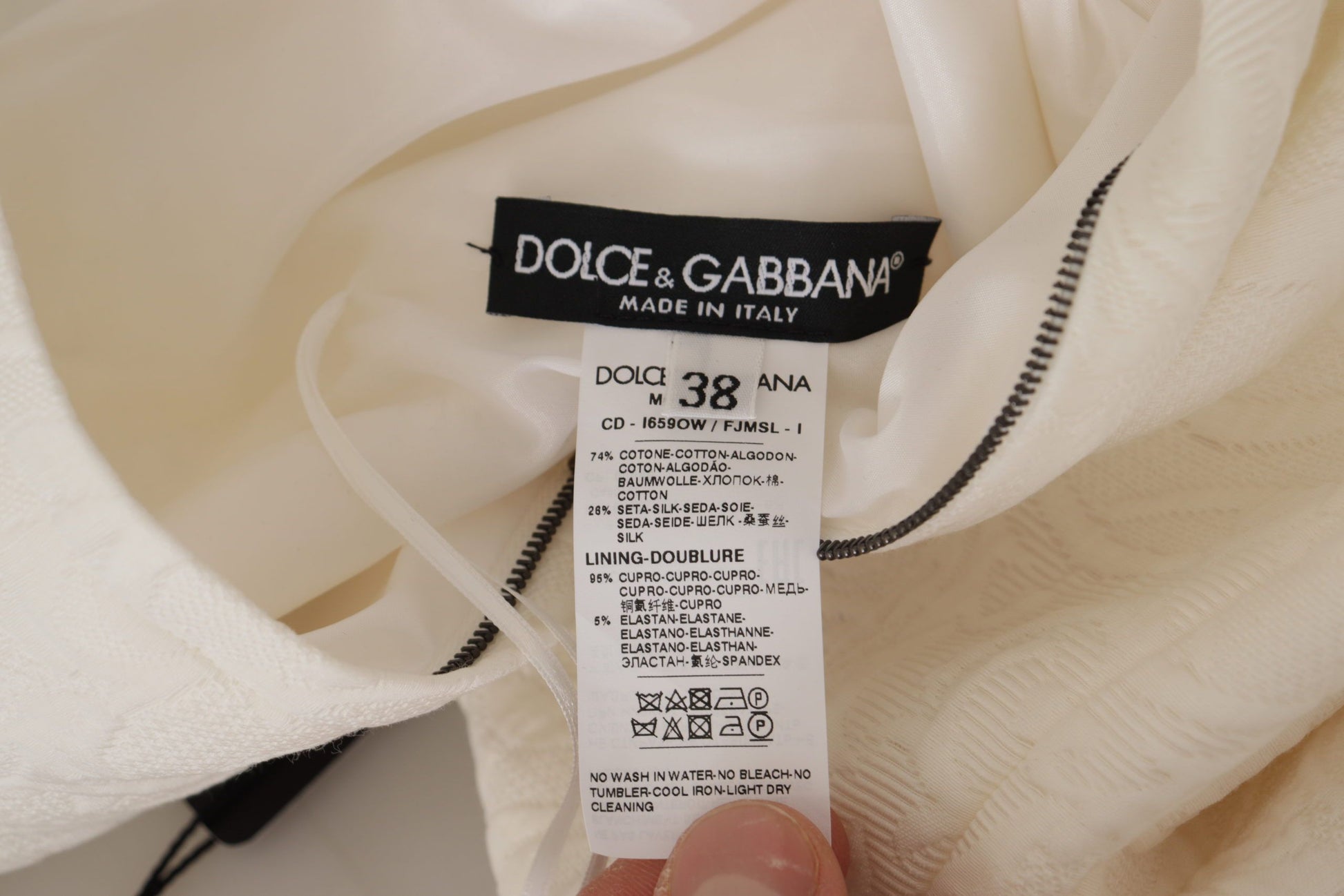 A white midi dress with floral brocade detailing from the brand Dolce & Gabbana