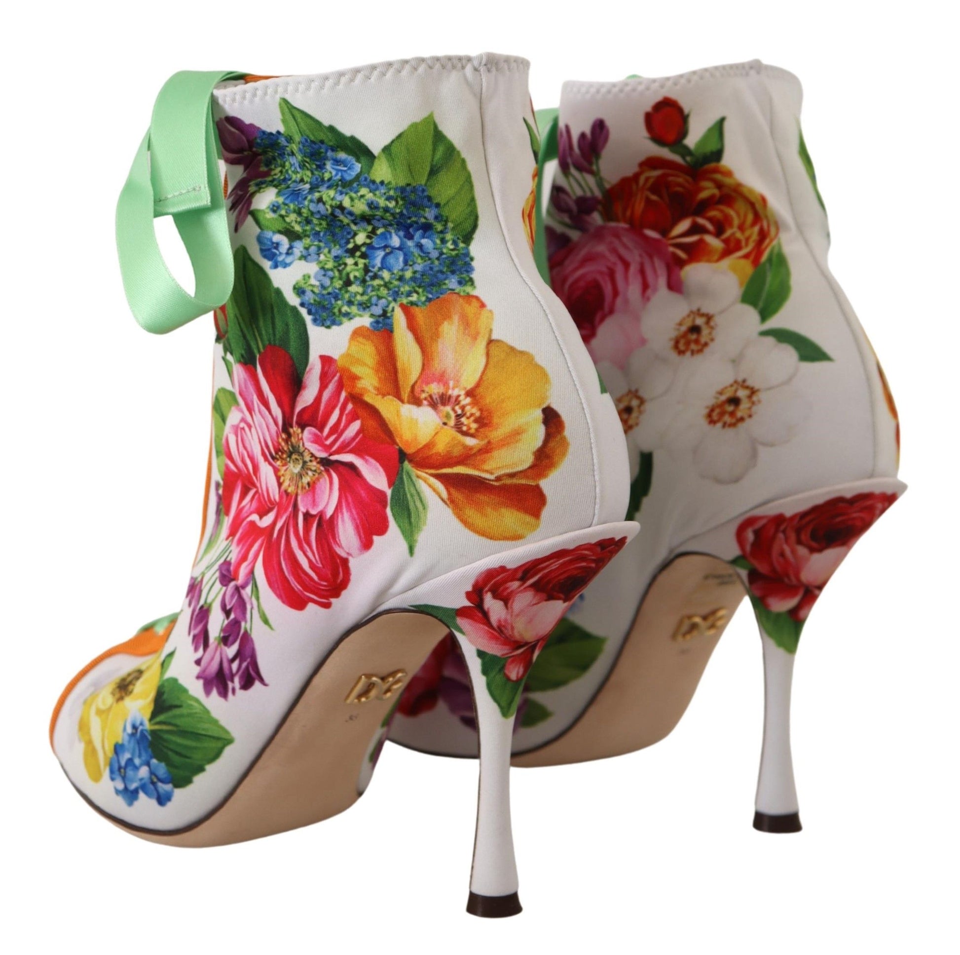 Pair of women's high heel boots with floral print and bow detailing
