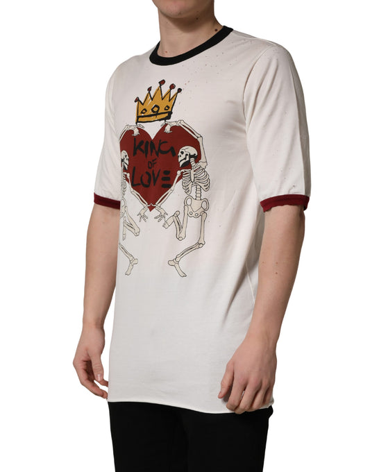 A white t-shirt with a graphic print of a skeleton and heart, featuring the text "King of love" in red