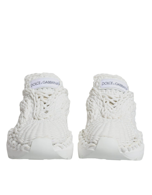 Pair of white knitted sneakers with black text on side, featuring a unique design and brand logo