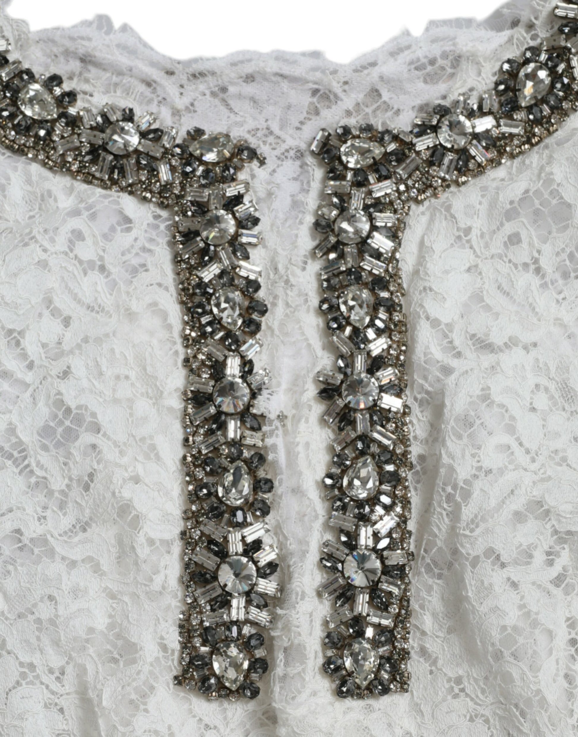 A white lace dress with crystal embellishments on the neckline and shoulders