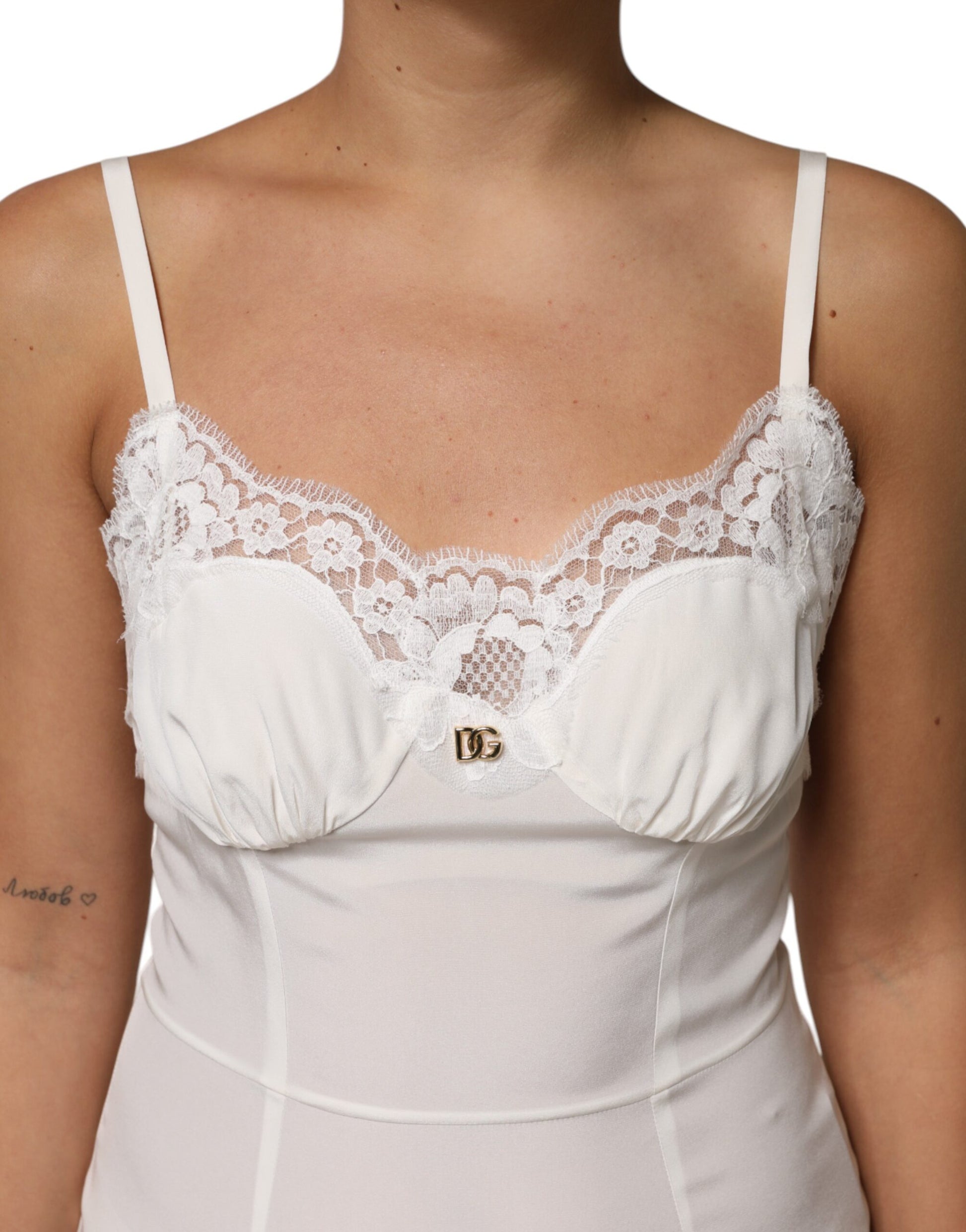 A white lace dress with a D&G logo, featuring a silky texture and sleepwear design