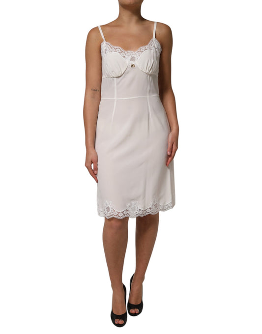 A white lace dress with gold logo, featuring a silky texture and designed for sleepwear