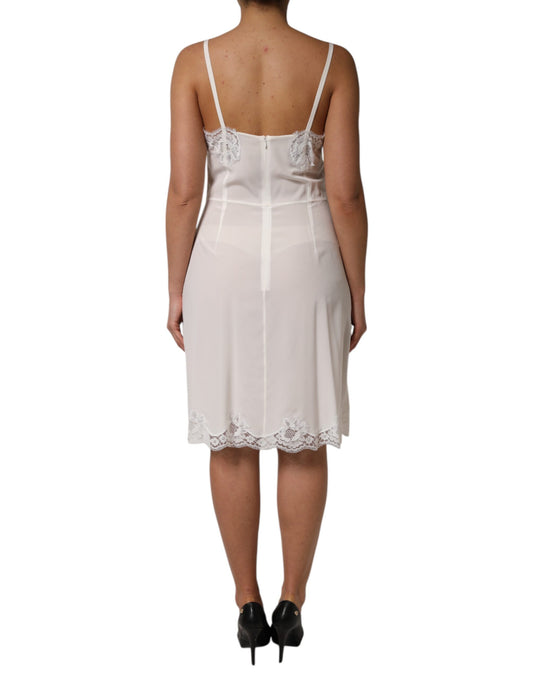 A white lace dress with a gold logo, featuring a silky texture and designed for sleepwear