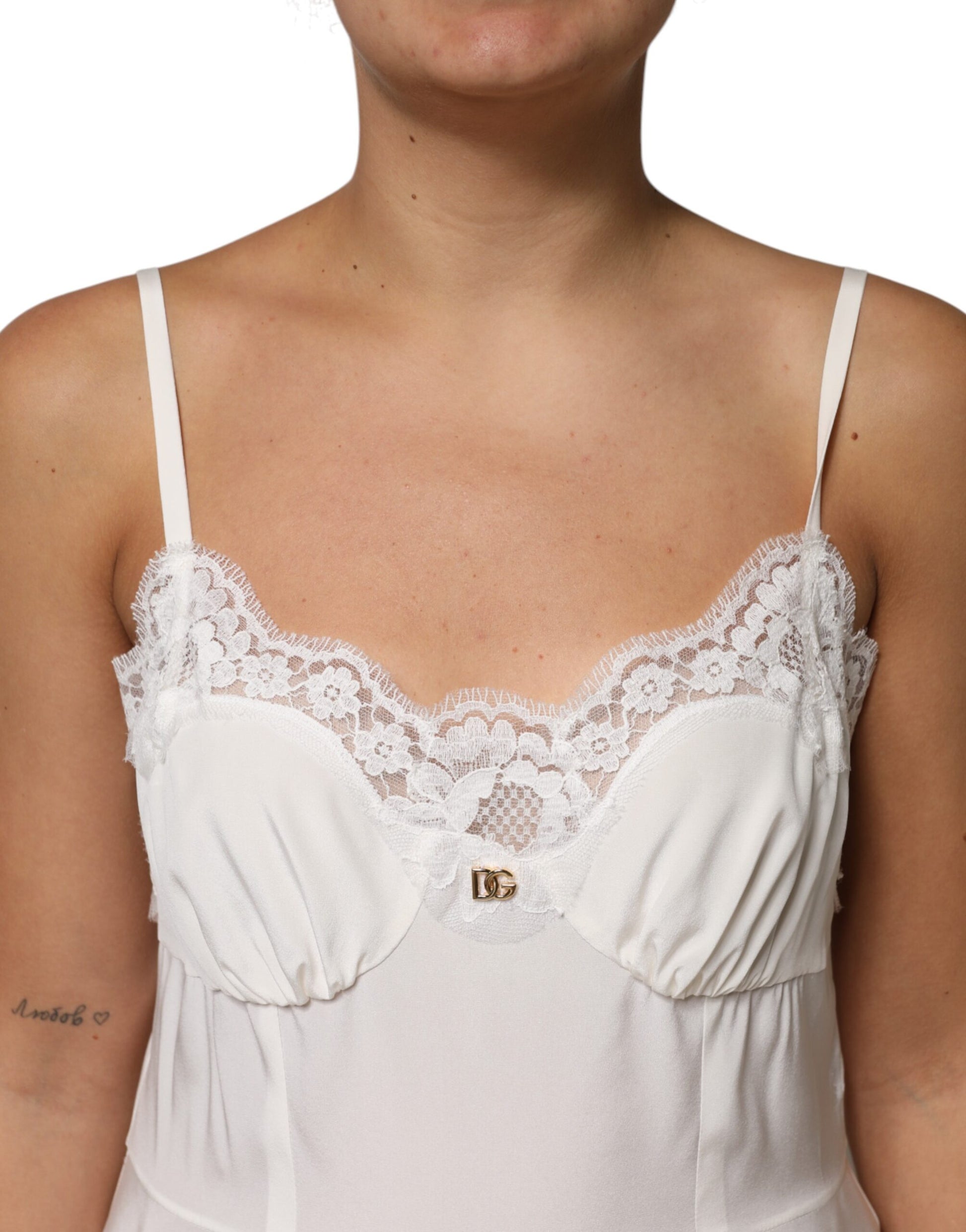 A white lace dress with a gold D&G logo and silk material