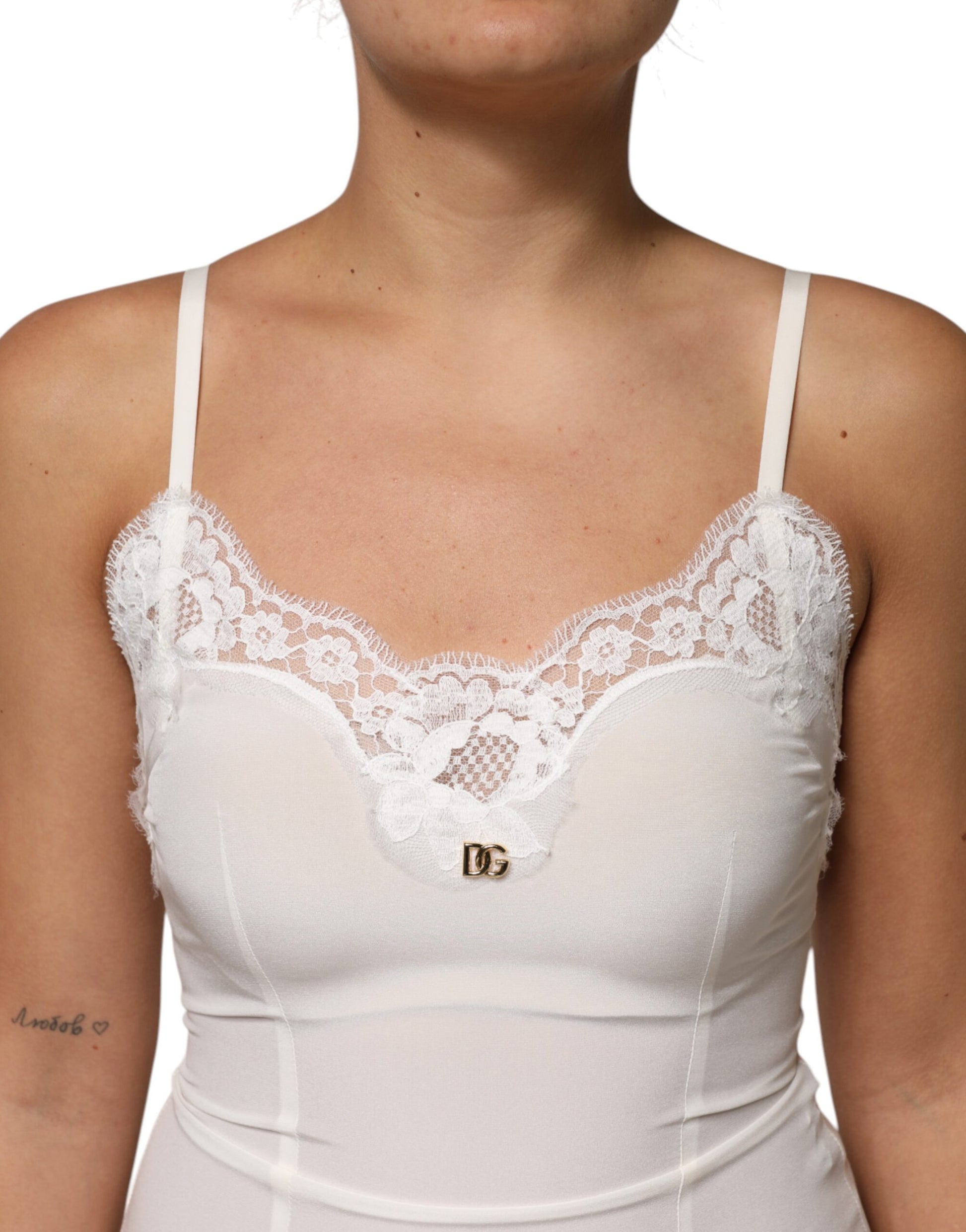 A white lace dress with a gold D&G logo on the chest