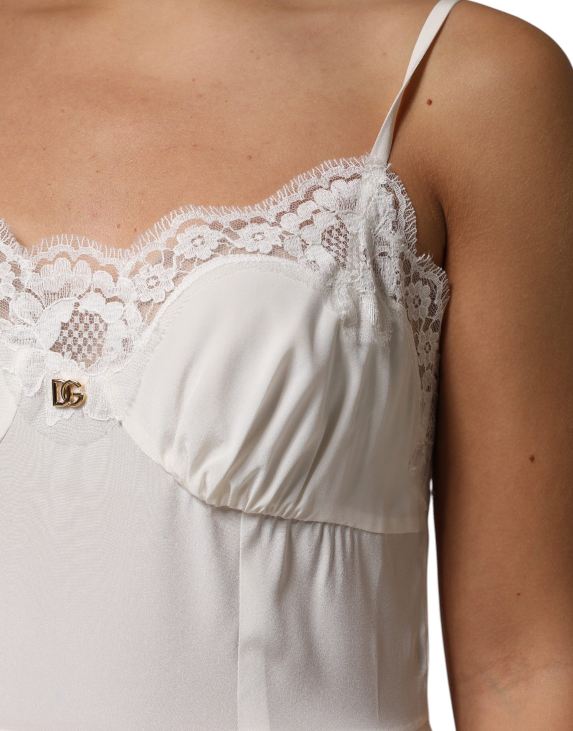 A white lace dress with a gold D&G logo on the chest