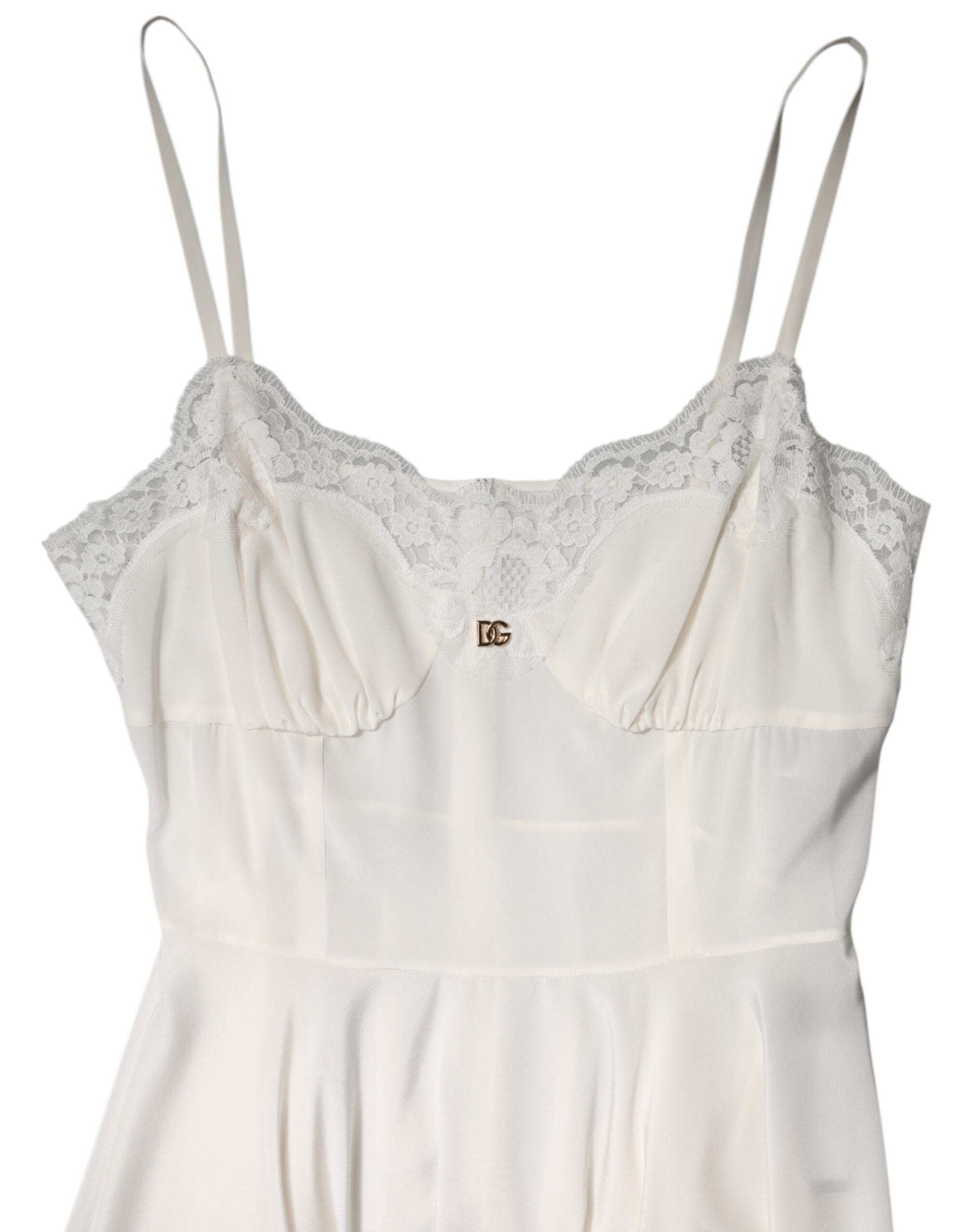 A white lace dress with a gold logo, featuring a silky texture and short sleeves
