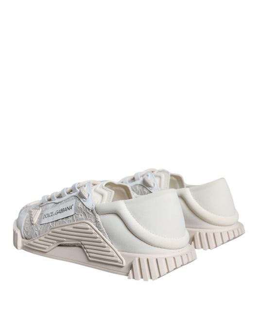 Pair of white lace-up sneakers with a low top, featuring a silver logo on the side