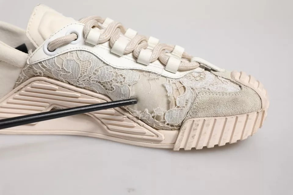 Pair of white lace-up sneakers with gold floral pattern on side