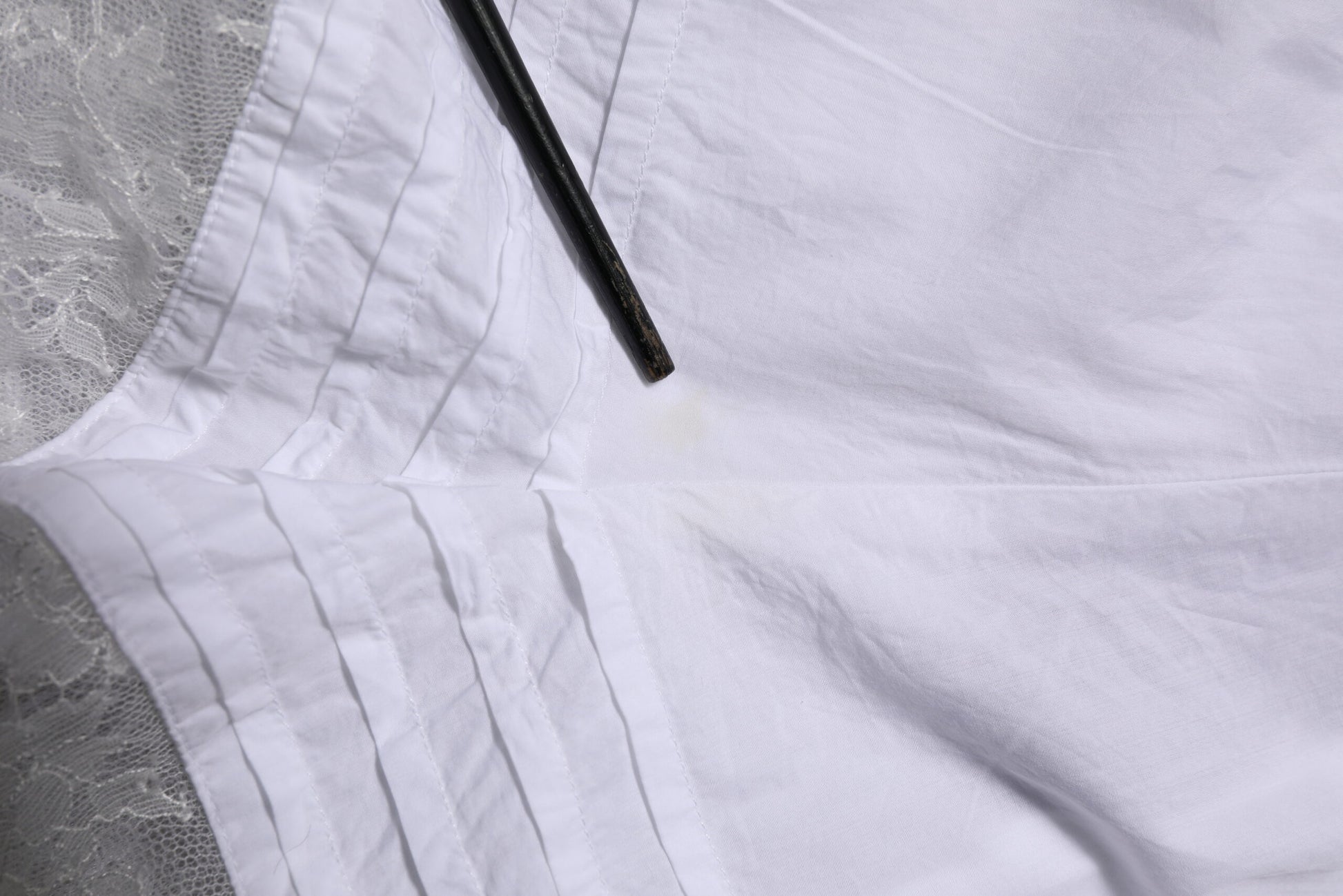 White cloth with black stitching on edge