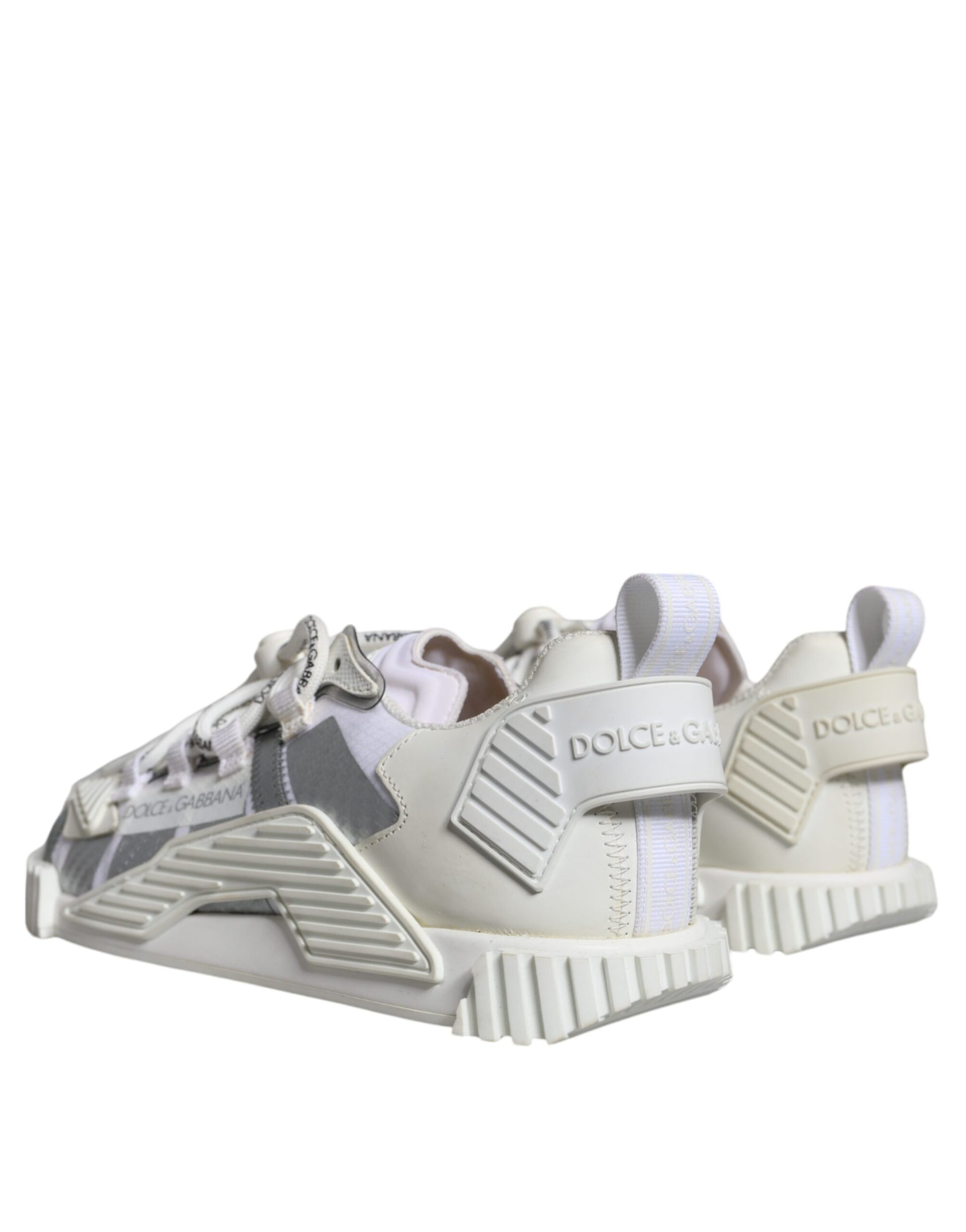 A pair of white lace-up sneakers with a low top, featuring the brand name "Dolce & Gabbana" and the model "NS1"